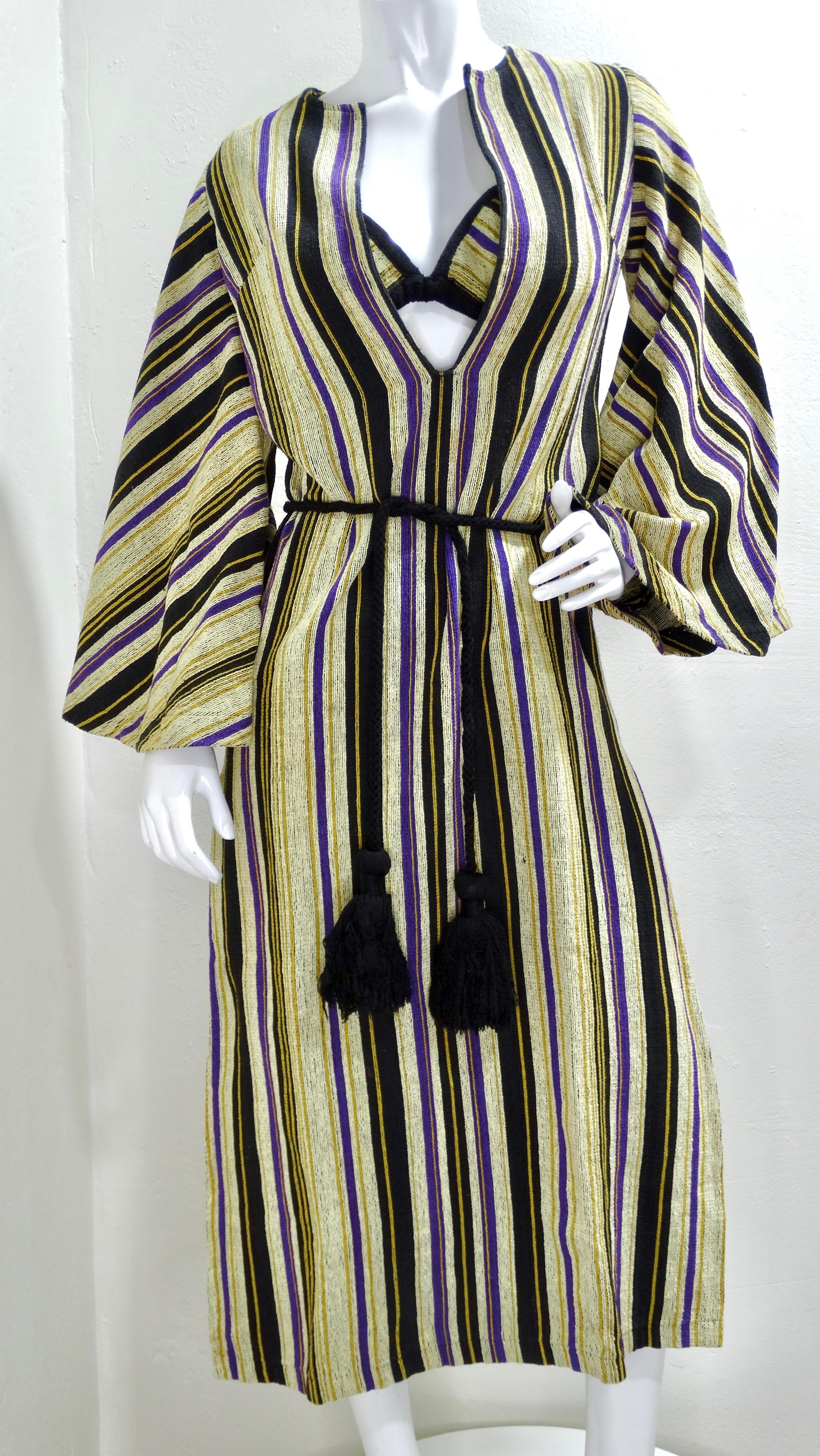 We're falling in love with Israeli designer Rikma- and you will too with this amazing 1970s dress! Made of a thick woven cotton fabric in Rikma's signature striped pattern in shades of purple, yellow, and black; this dress features a deep v-neck,