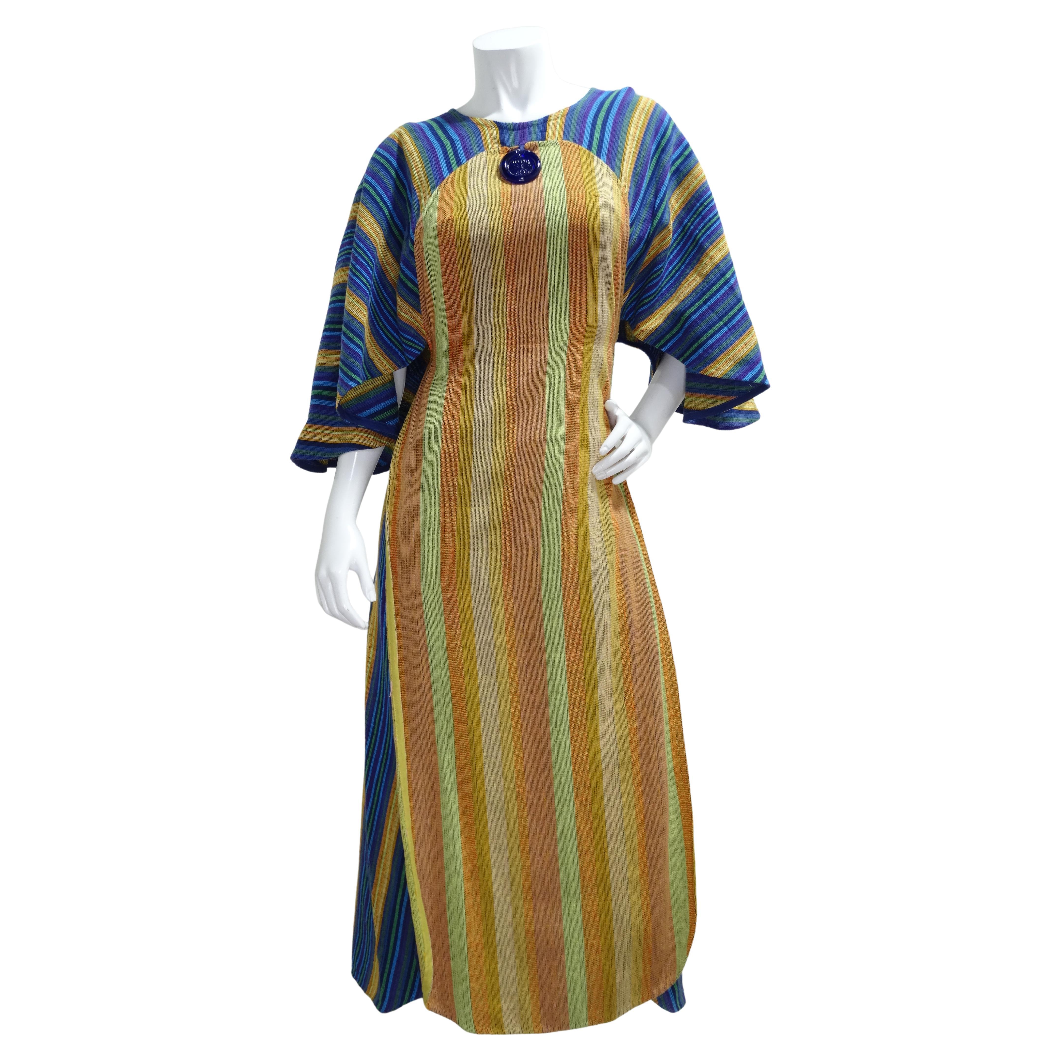 The beautiful details of this Rikma dress will have you hooked. This dress features a high-neck, maxi length, billowy sleeves, pendant depicting a Hanukkah menorah, color-blocking, and a tassel rope belt. Two ties close the front and the back giving