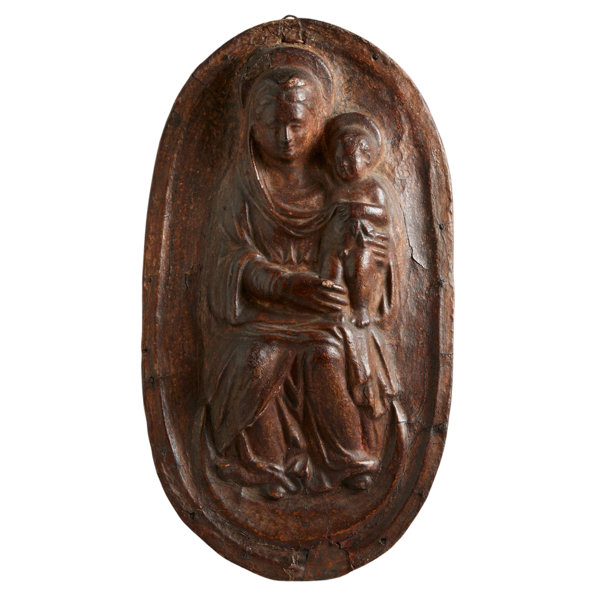 Leather relief depicting Madonna enthroned with Child on her lap