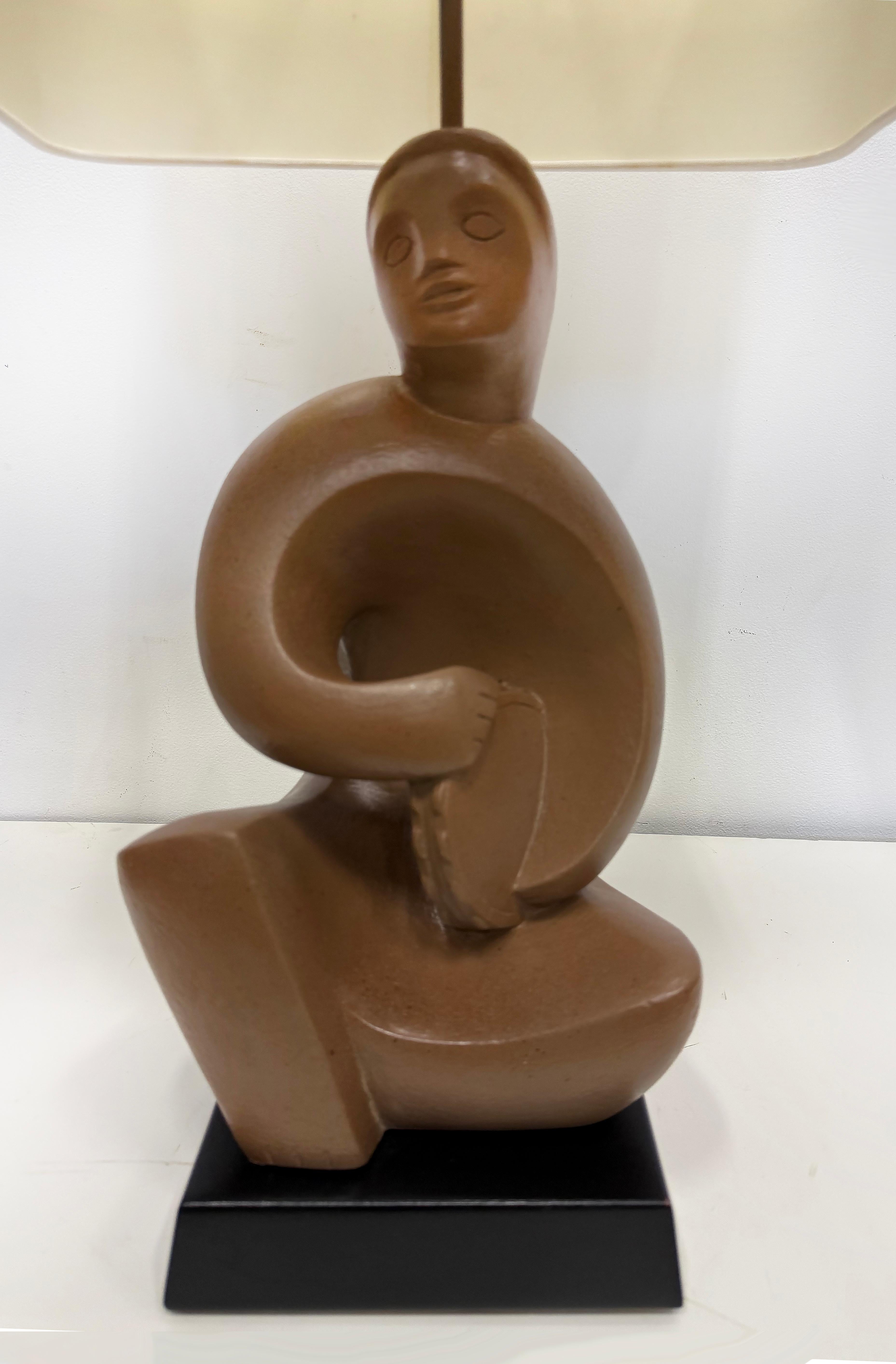 RIMA 1940s Cubist Abstract Plaster Musician Lamp, Henry Moore Influenced

Offered for sale is a rare 1940s plaster table lamp by RIMA of New York.  The lamp base is an abstract sculpture of a musician with a tambourine that is inspired by Henry