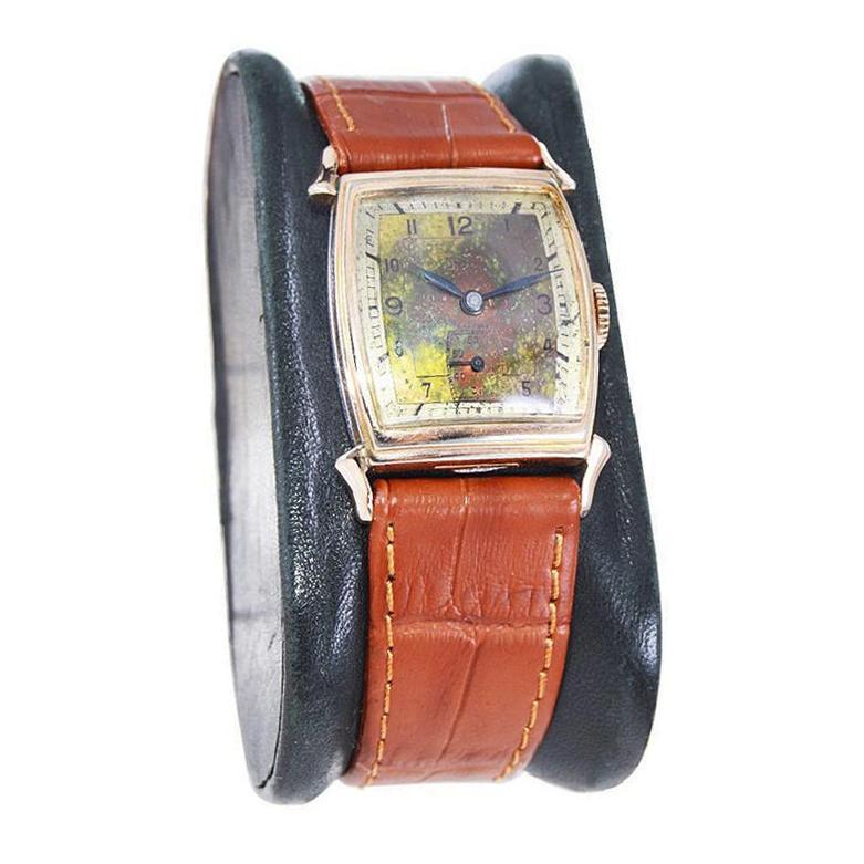 FACTORY / HOUSE: Rima Watch Company
STYLE / REFERENCE: Art Deco / Tonneau Shape
METAL / MATERIAL: Rose Gold Filled 
CIRCA / YEAR: 1940's
DIMENSIONS / SIZE: Length 34mm x Width 22mm
MOVEMENT / CALIBER: Manual Winding / 17 Jewels 
DIAL / HANDS: