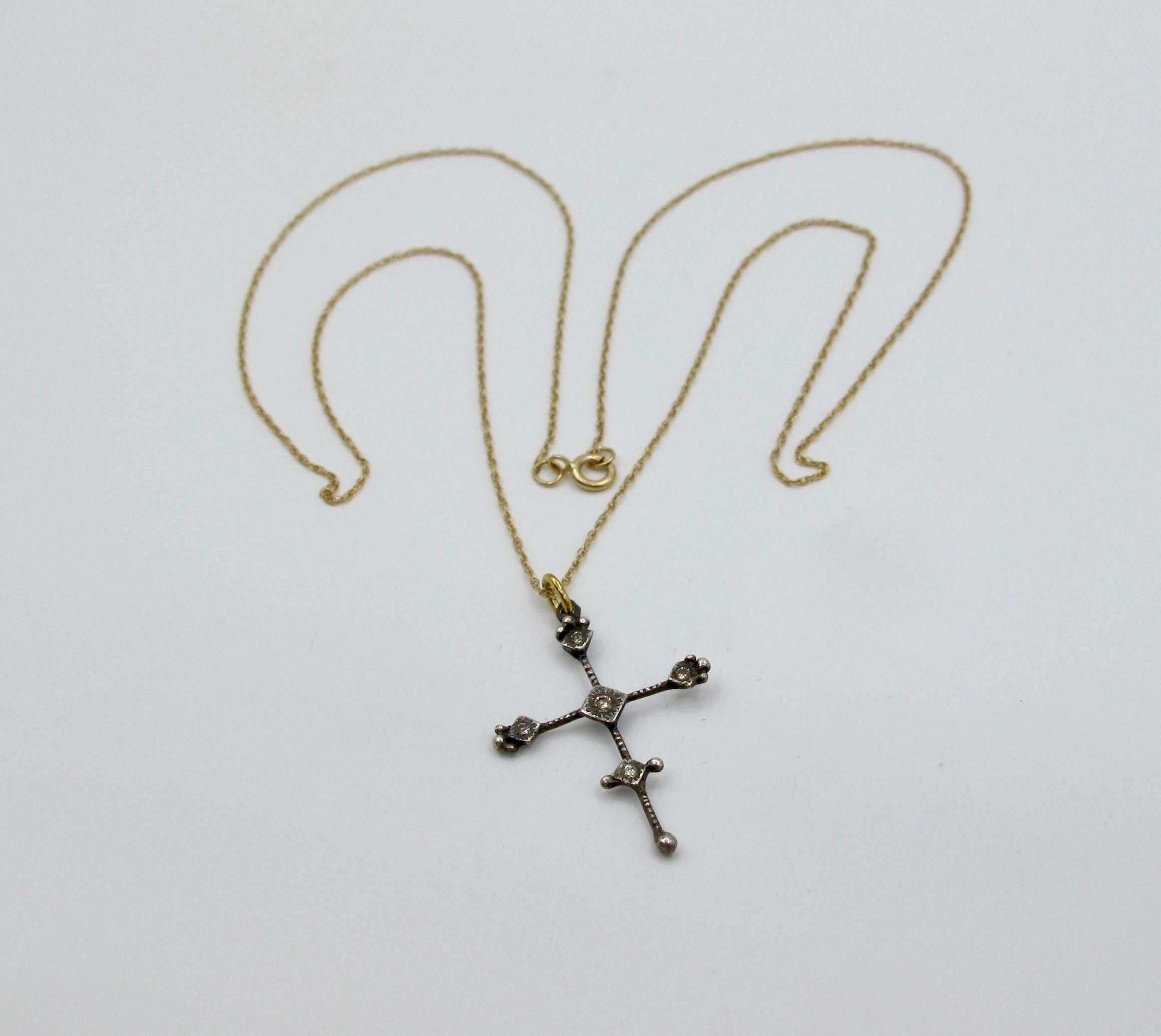 Rima Jewels' signature small delicate sterling silver cross set with bright champagne diamonds and strung on a fine 18
