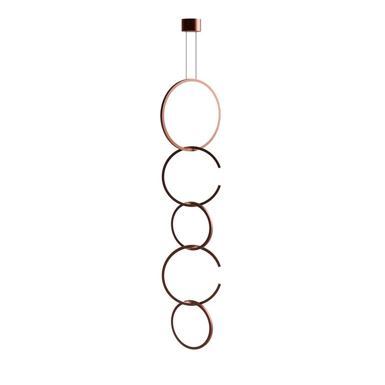 Powerful yet elegant, this Minimalist suspension light is marked by a sleek aesthetic that provides a versatile option for a multitude of modern interiors. The linear profile is dominated by a series of stackable rings of different sizes crafted of