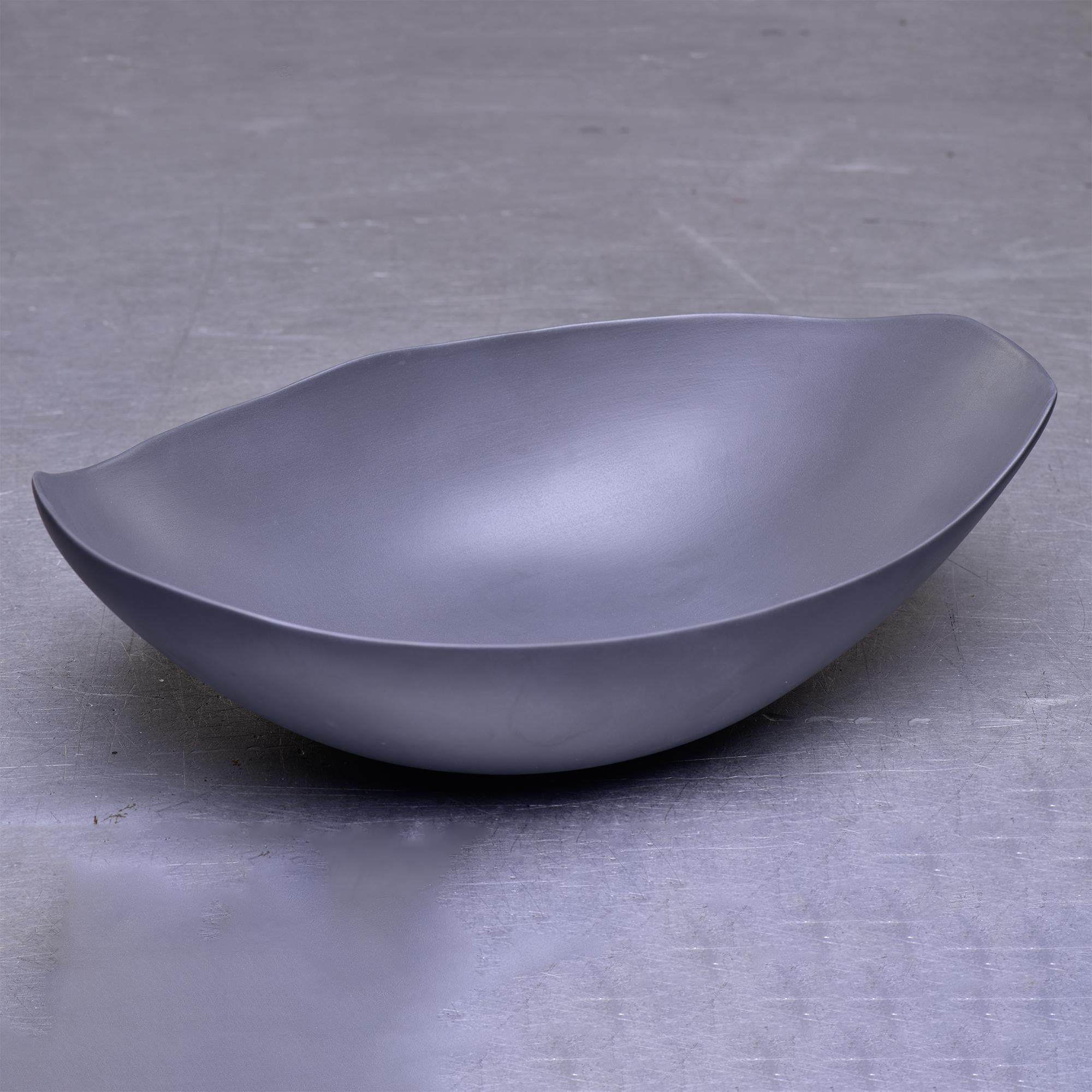 New Italian art pottery center bowl by Rina Menardi has an elongated irregular shape, delicate thin walls and a neutral graphite color glaze. Other pieces from this maker available. 
  