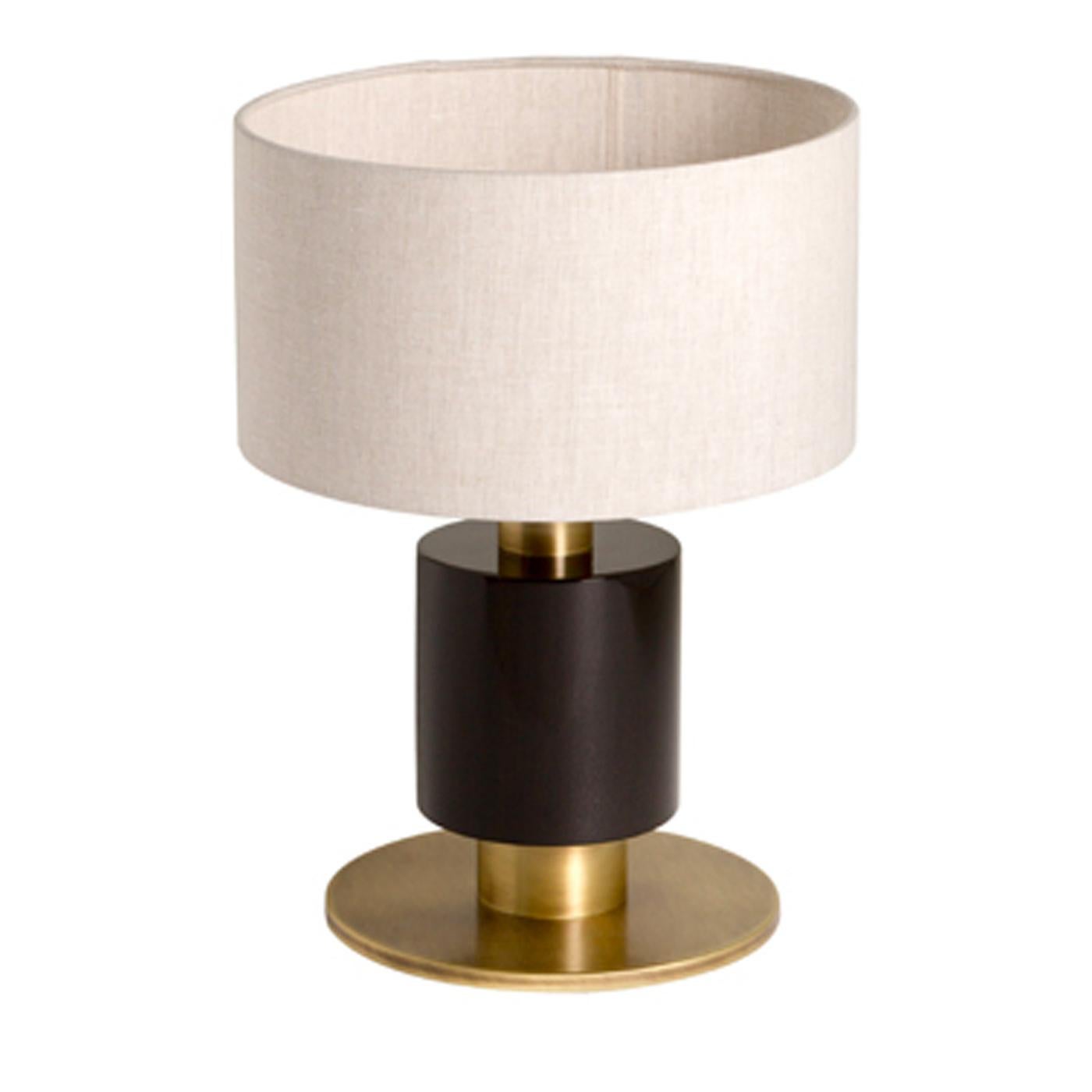 From a small collection of lighting styles, the Rindo bedside table lamp is characterized by its quirky chic style. Featuring walnut veneer with a dark glossy finish, the lamp is accented with a burnished brass finish and topped with a drum