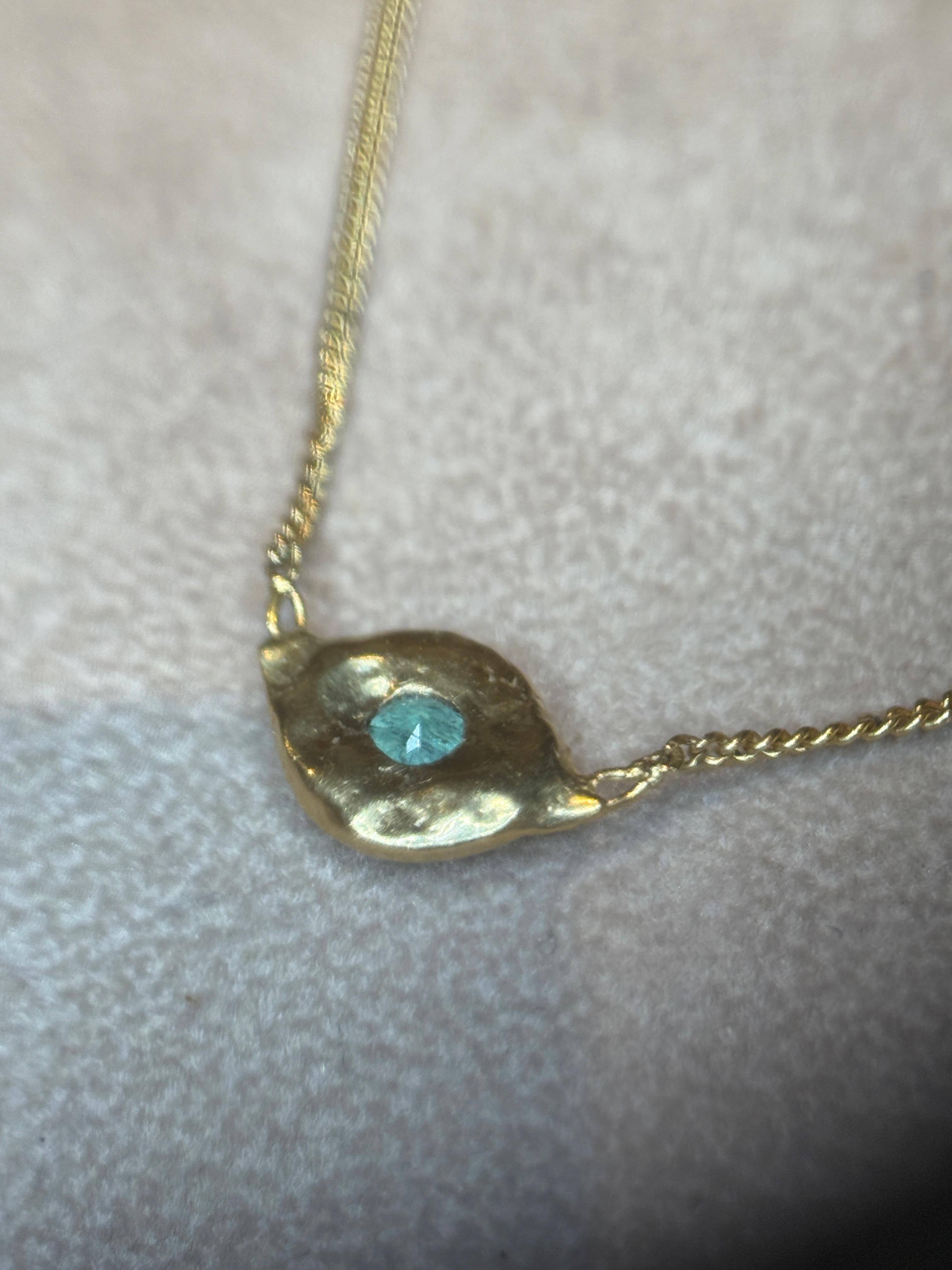 Discover the timeless tale of the evil eye, a belief that originated in ancient Greece and Rome and continues to captivate to this day. The  “Rineia” Evil Eye Necklace, handcrafted from 18 Ct gold, not only exudes luxury but also it serves as a