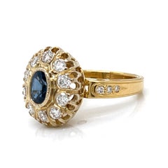 RING-0.60 Carat Oval Blue Sapphire and 1.20 CTW Diamond in 18K Yellow Gold