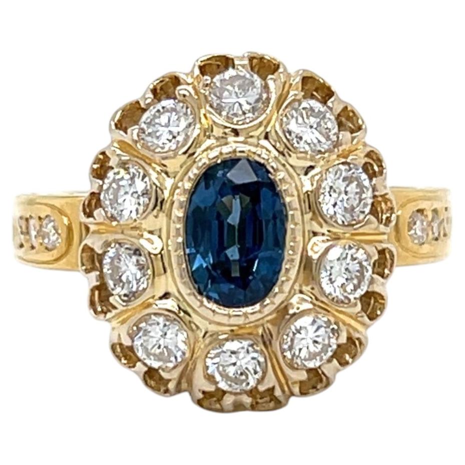 RING-0.60 Carat Oval Blue Sapphire and 1.20 CTW Diamond in 18K Yellow Gold