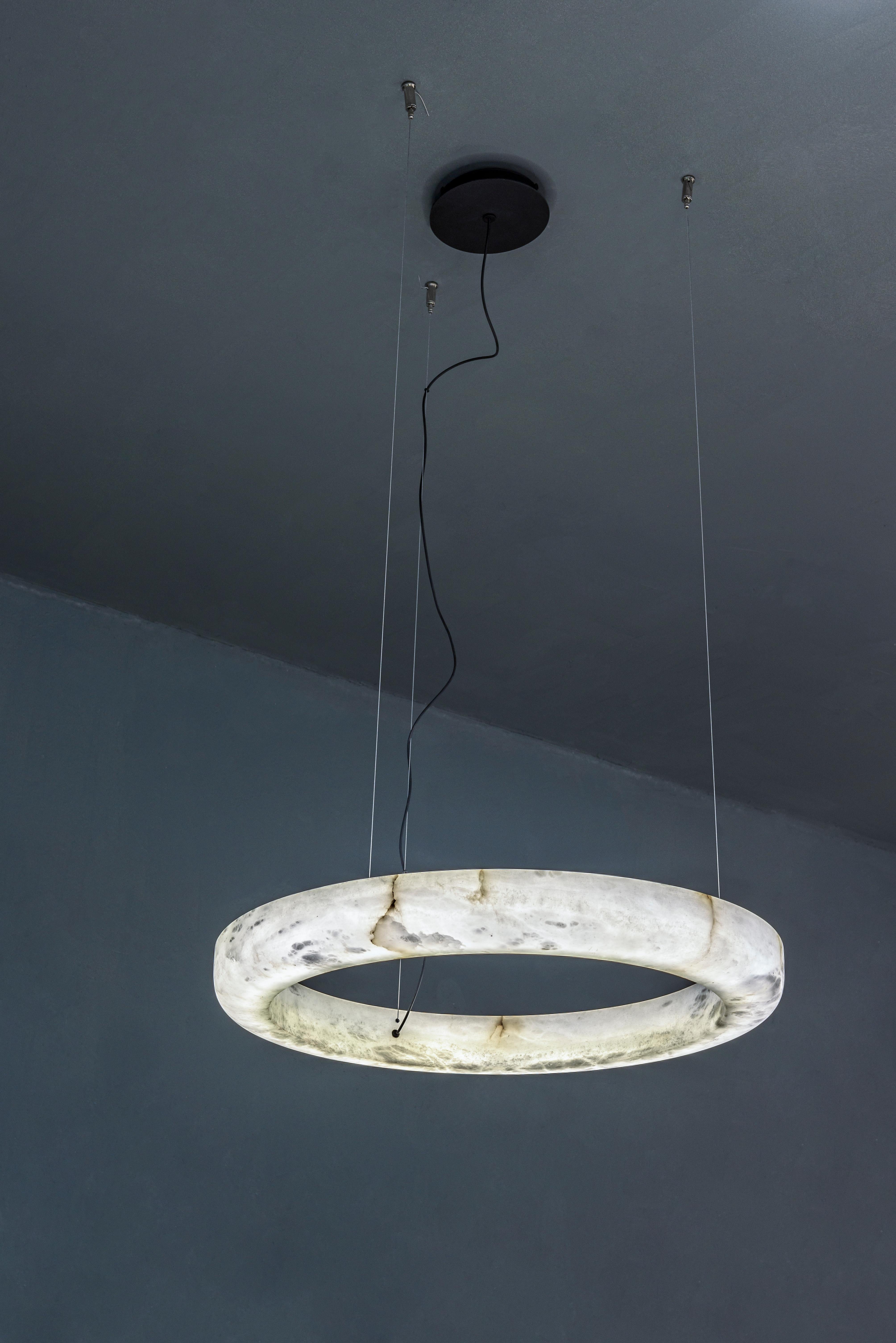 Ring 100 Pendant Lamp by United Alabaster
Dimensions: D 100 x H 200 cm
Materials: Alabaster

All our lamps can be wired according to each country. If sold to the USA it will be wired for the USA for instance.

A suspended alabaster ring with a