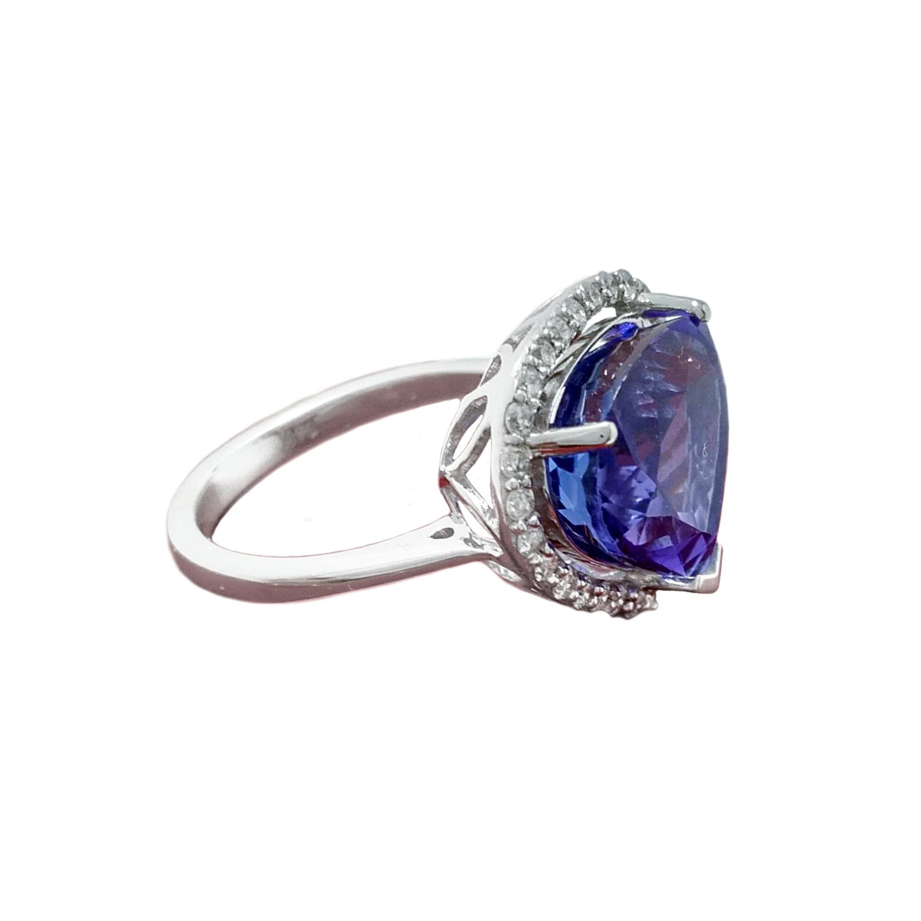 Stunning tanzanite diamond cocktail ring. Violet-blue, high luster, pear faceted, 6.12 carats natural tanzanite encased in basket mounting with one split and two round prongs, accented with round brilliant cut diamonds. Contemporary handcrafted