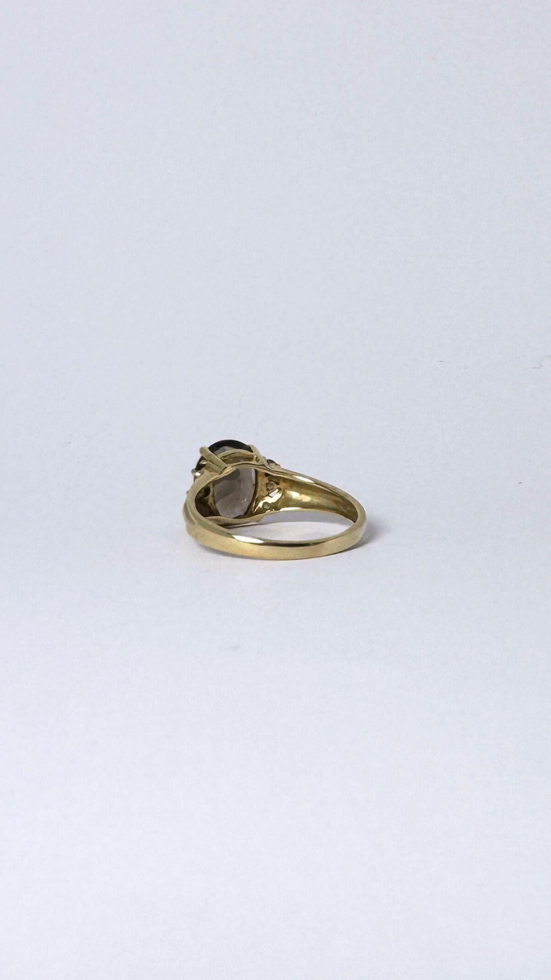 Women's Ring 14 carat gold with smokey quarts  2 carat, surrounded with little quarts  For Sale