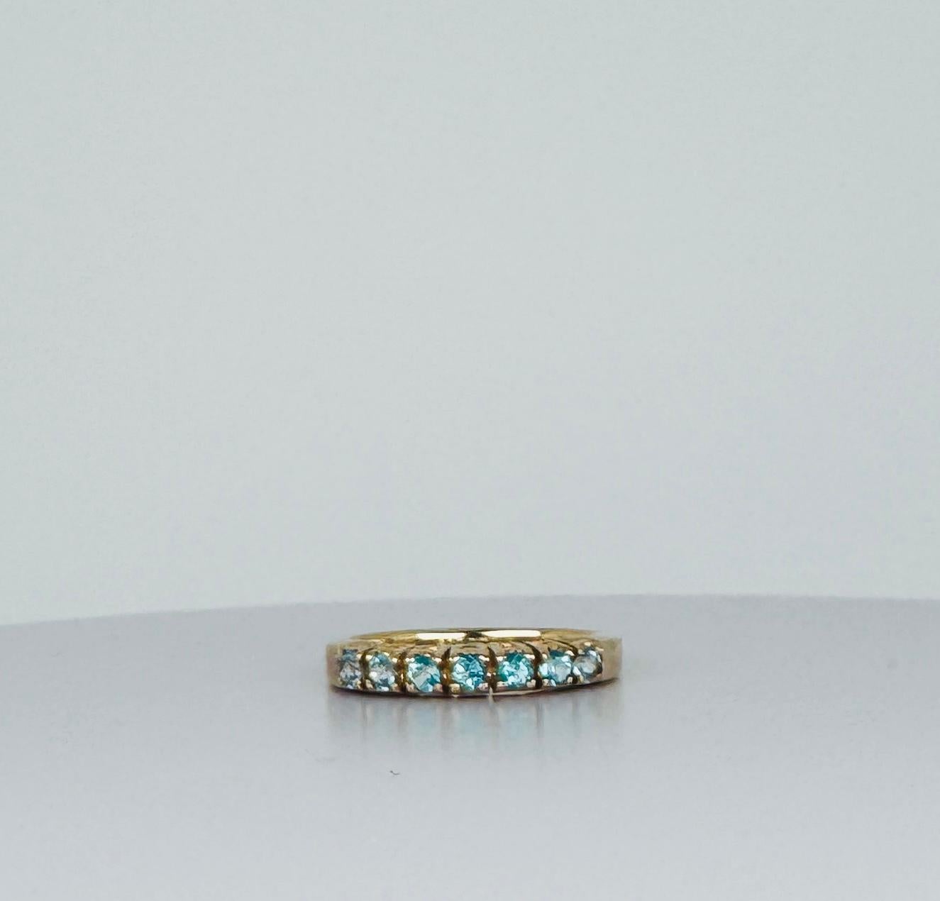 Add a touch of vibrant elegance to your collection with this stunning 14 carat ring, featuring round cut aquamarines. This ring combines classic gold craftsmanship with the vivid color of these gemstones,  making it a standout piece for any