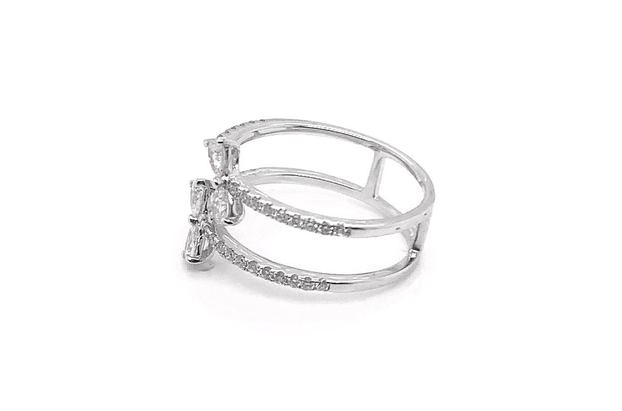 A 14kt white gold ring that dances with elegance, featuring ribbon-shaped pear diamonds gracefully adorned with two lines of dazzling diamonds. This design is a harmonious blend of artistry and luxury, where the pear diamonds resemble delicate