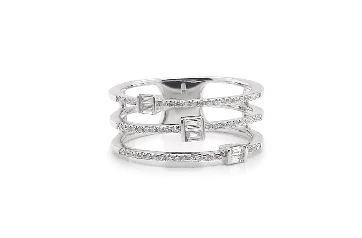A 14kt white gold ring adorned with three delicate lines of diamonds, this piece is a symphony of simplicity and sophistication. Its understated beauty makes a lasting statement, drawing the eye to the timeless allure of shimmering diamonds against