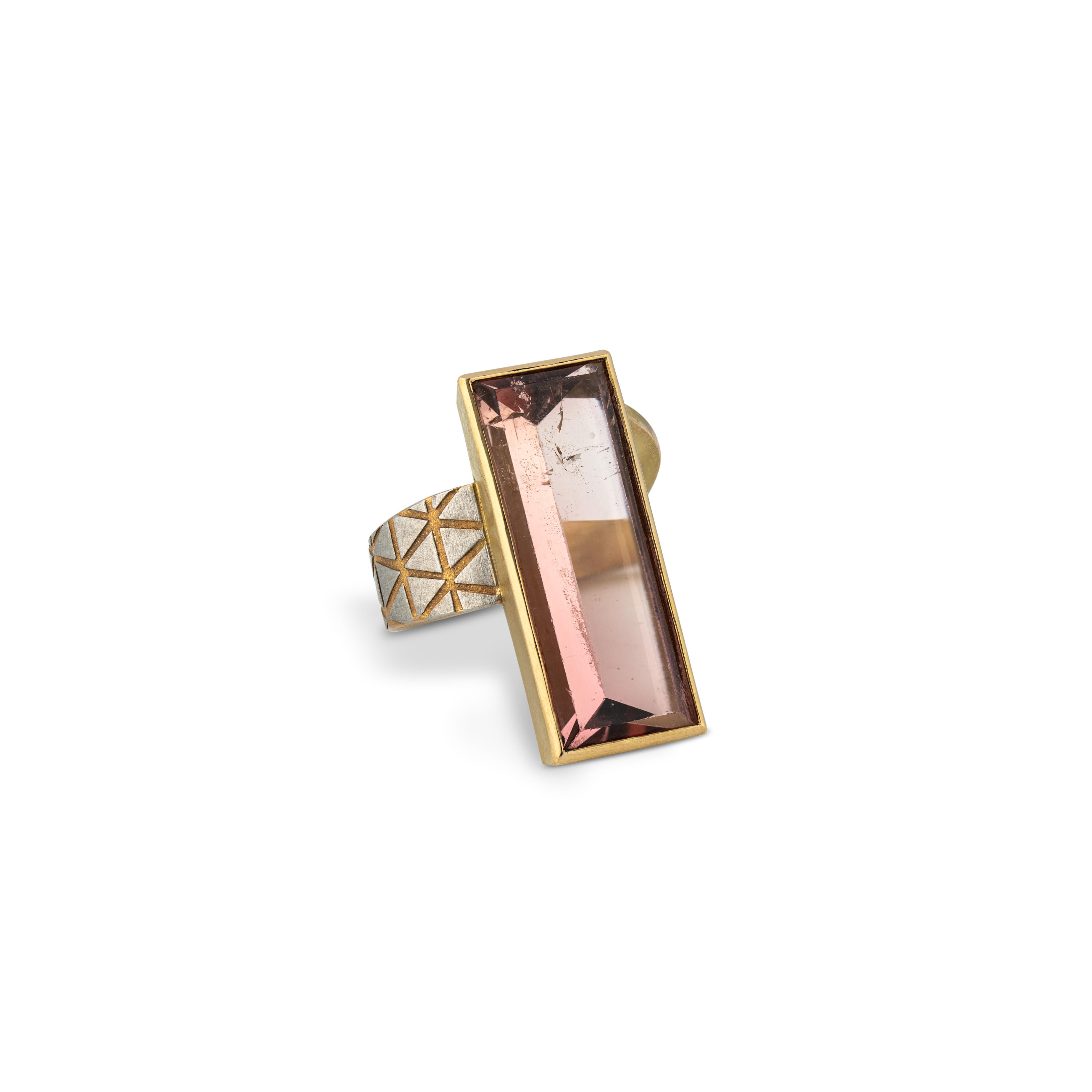 Magnificent ring by Zobel is a masterpiece of craftmanship. The unusual design is typically for Atelier Zobel.
With a rose colored tourmaline of 30 x 11 mm / 1.18 x 0.43 inches, set in yellow gold on a yellow gold ring band which is decorated with a