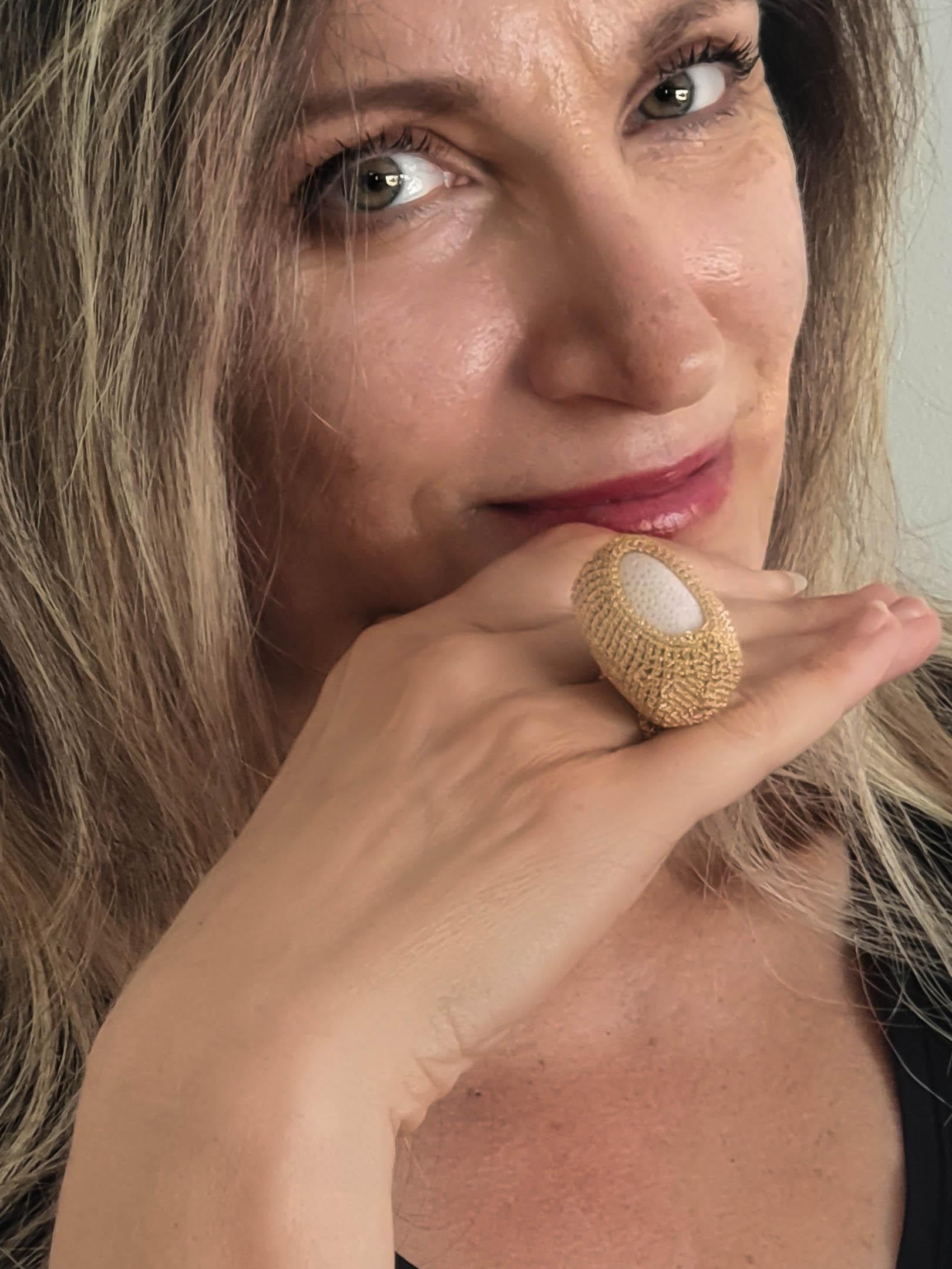 Beautifully crafted hand crochet gold thread (7.31 grams) ring with a natural white Coral (weighing 20.08 grams). It is an eye catching ring with a lot of presence. This ring is a 7.5 US size. It can be stretched a little to fit a larger