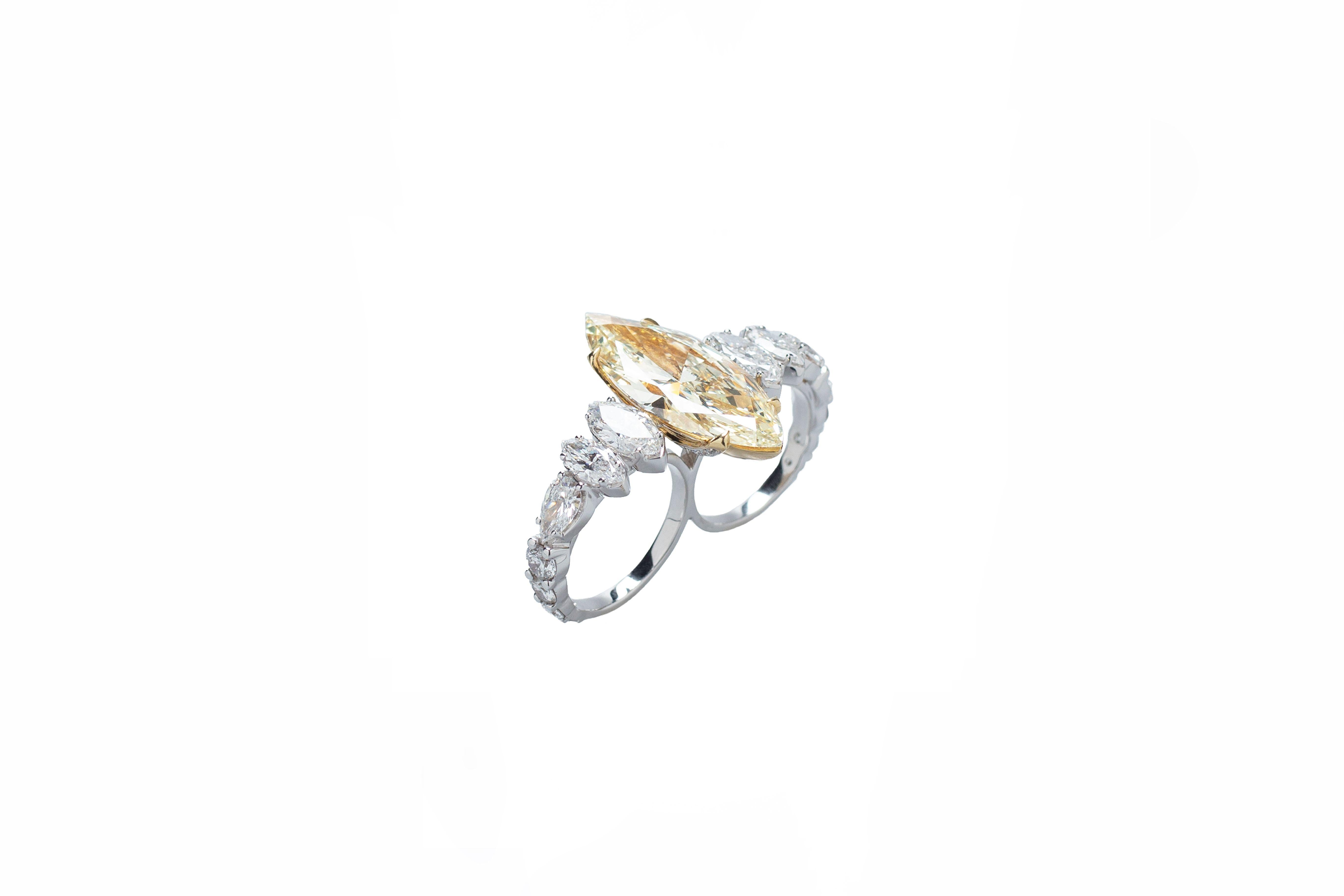 Designed exclusively by Ara Vartanian, this 18k White Gold two finger Ring features a Fancy Light Yellow Diamond  in a navette cut, weighing 11,78ct (eleven carats and seventy-eight points) , along with 5.45ct (five carats and forty-five points)
