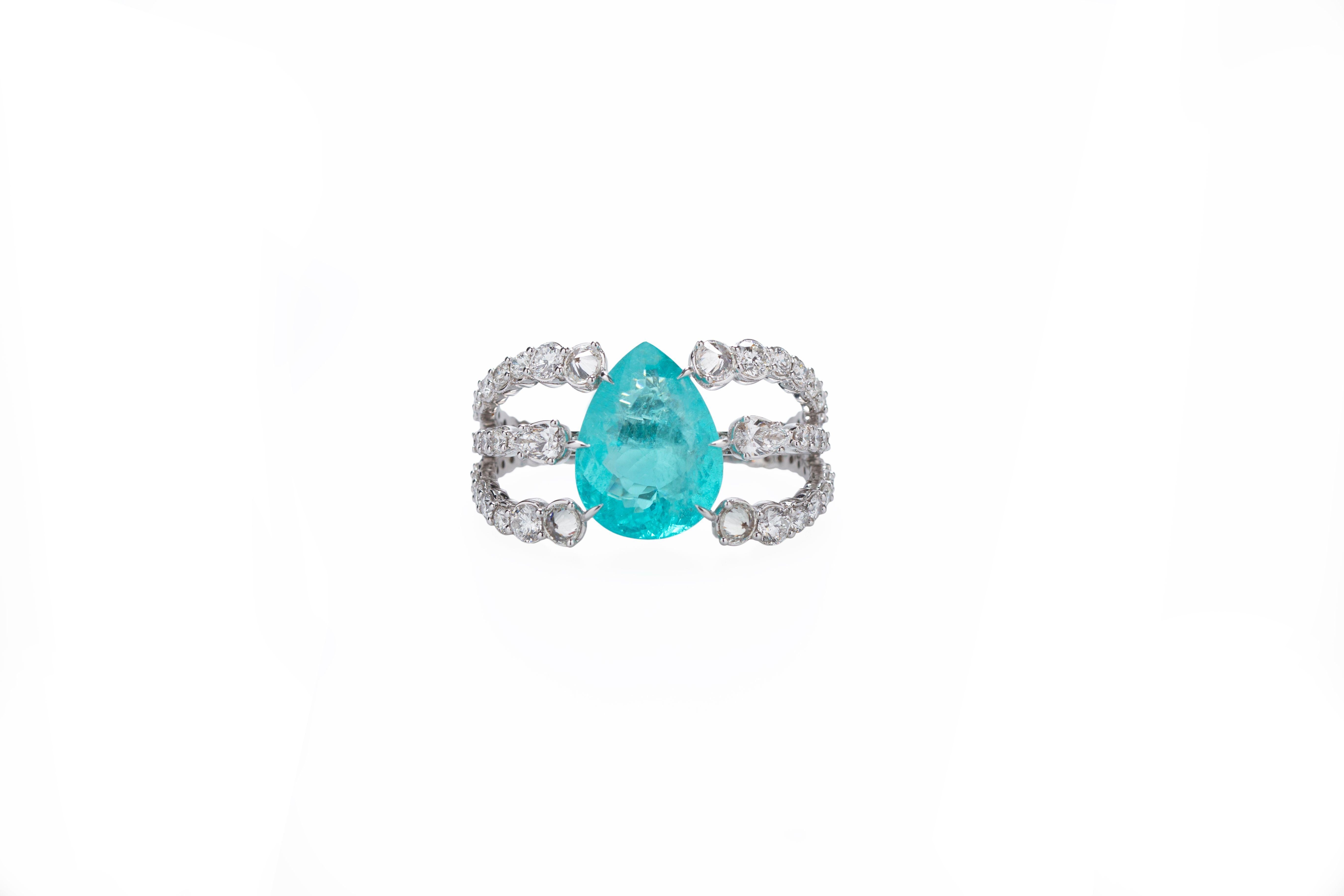 Designed exclusively by Ara Vartanian, this 18k White Gold two finger Ring features a 27,76ct (twenty-seven carats and seventy-six points) Paraiba Tourmaline in a oval cabochon cut, along with a total of 9,14ct (nine carats and fourteen points) 
