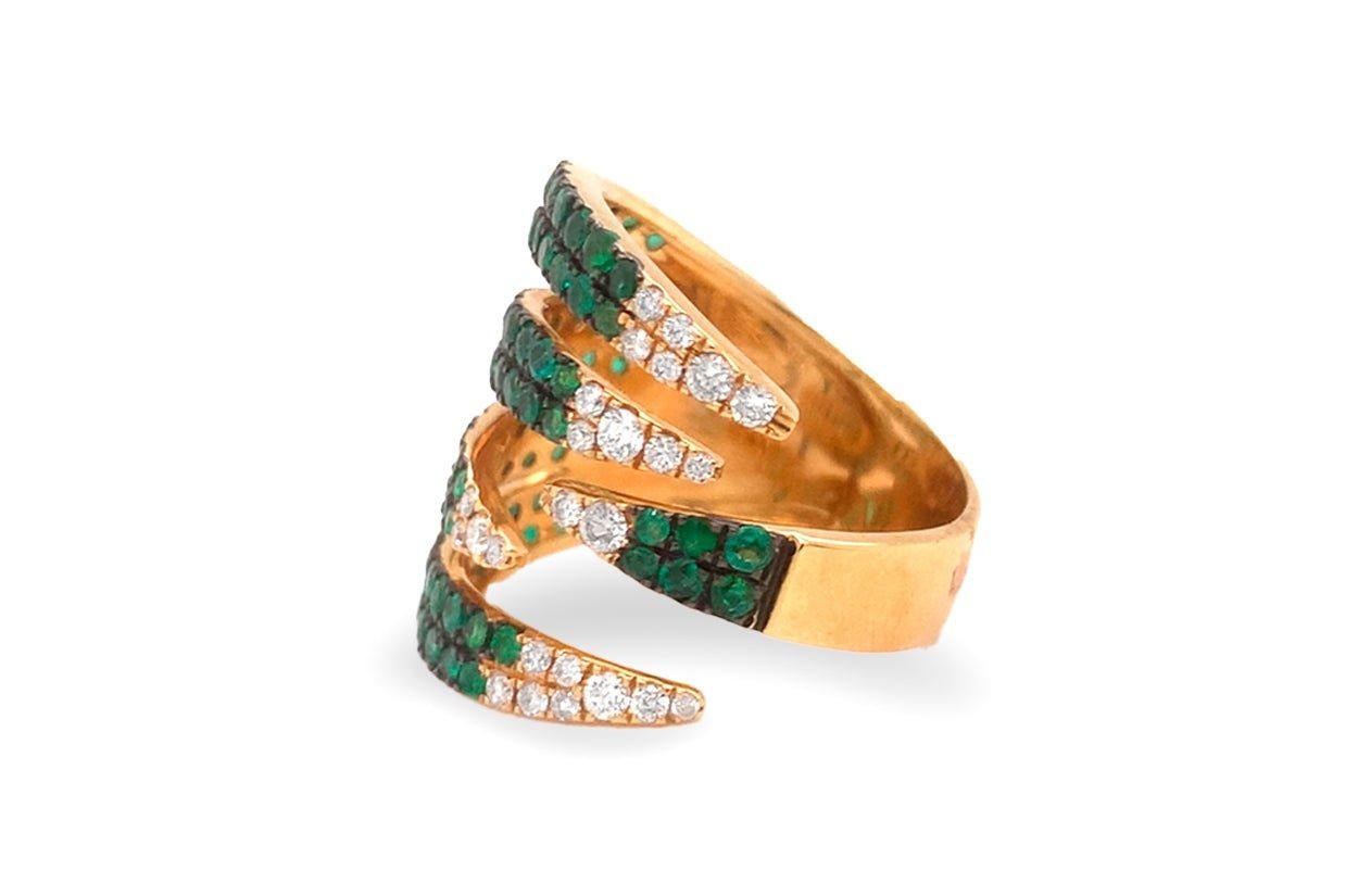 Introducing and exquisite masterpiece - a claw ring meticulously crafted in 18kt yellow gold, adorned with captivating emeralds and diamonds. This ring effortlessly combines nature's vivid beauty with timeless luxury, a true embodiment of elegance