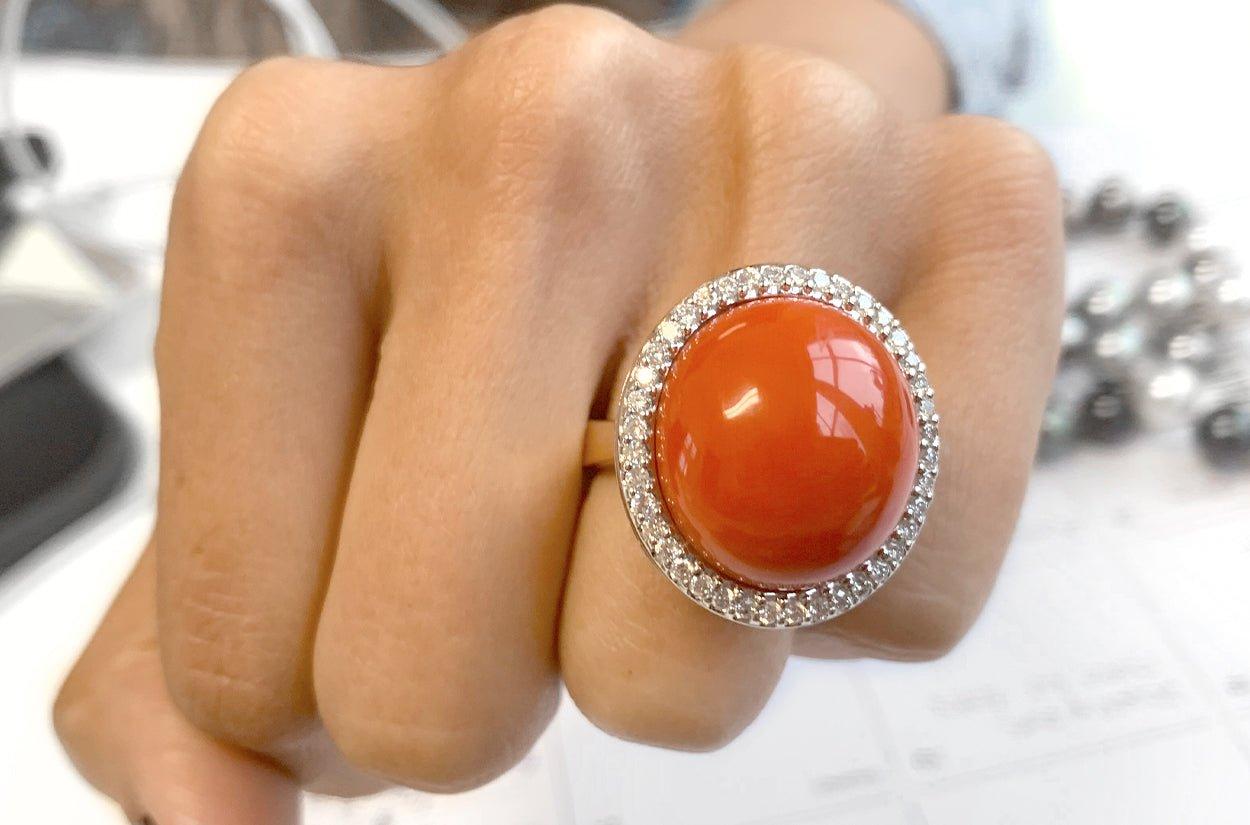 This 18kt white and rose gold cocktail ring with top-quality coral cabochon as the center stone, surrounded by diamonds would make a stunning and unique piece of jewelry. The Contrasting colors of the gold and the vibrant coral, along with the