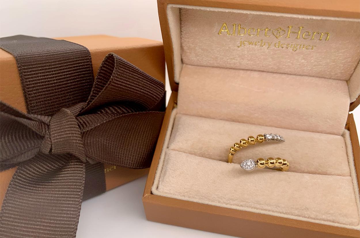 The snake-shaped ring in 18kt two-tone gold is a symbol of both elegance and mystique. Its sinuous design gracefully coils around your finger, reminiscent of a slithering serpent. The combination of two-tone gold adds depth and intrigue to this