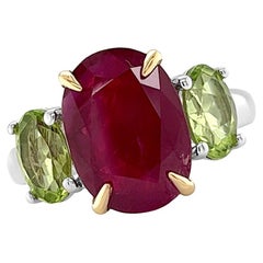 Ring 18kt Gold GIA Oval Ruby GIA 4.59 cts & 2 Oval Peridots 1.71 cts.