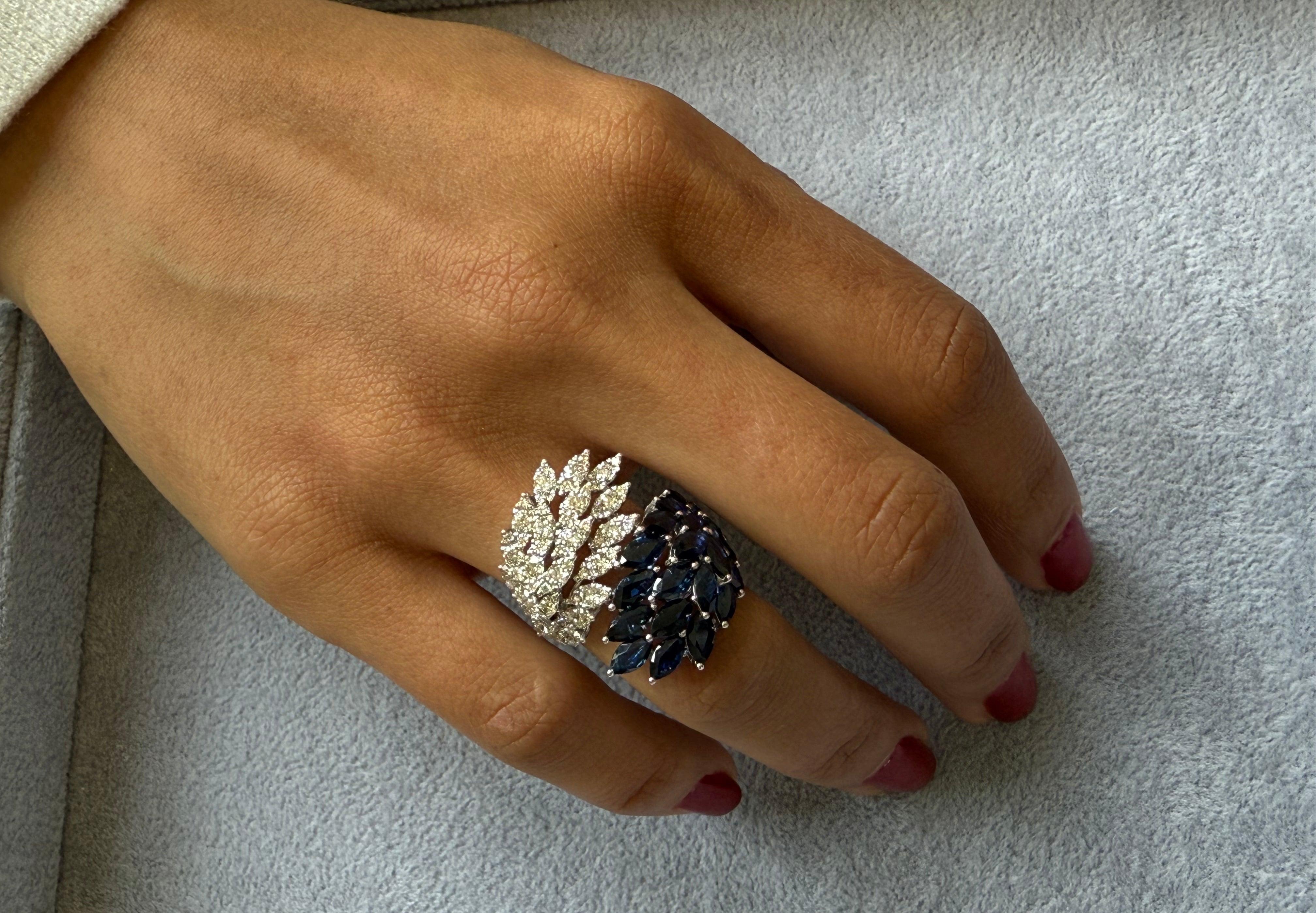 Inspired by nature’s grace and timeless beauty, this exquisite ring is sculpted in radiant 18Kt gold, delicately shaped into a motif of golden leaves. At its heart lies a breathtaking 5.11 carat marquise-cut blue sapphire, its rich hue evoking depth