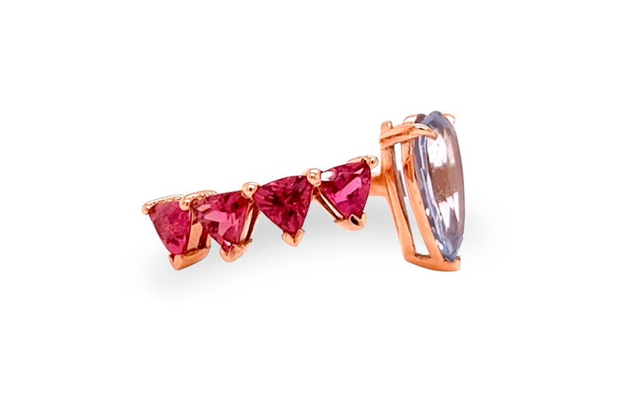 An exquisite masterpiece of jewelry craftmanship, this floating ring is a mesmerizing blend of luxury and elegance. Crafted from lustrous 18kt rose gold, it delicately cradles a resplendent rubellite trillions and captivating Ceylon sapphire,