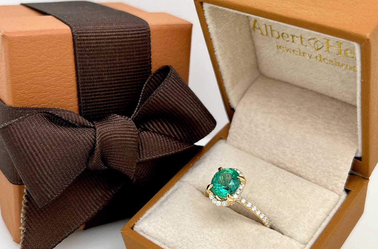A radiant 1.76-carat round emerald glows at the heart of this exquisite 18kt yellow gold ring, gracefully embraced by 48 shimmering diamonds totaling 0.48 carats — a timeless symbol of enduring love. 

Size 6.5
