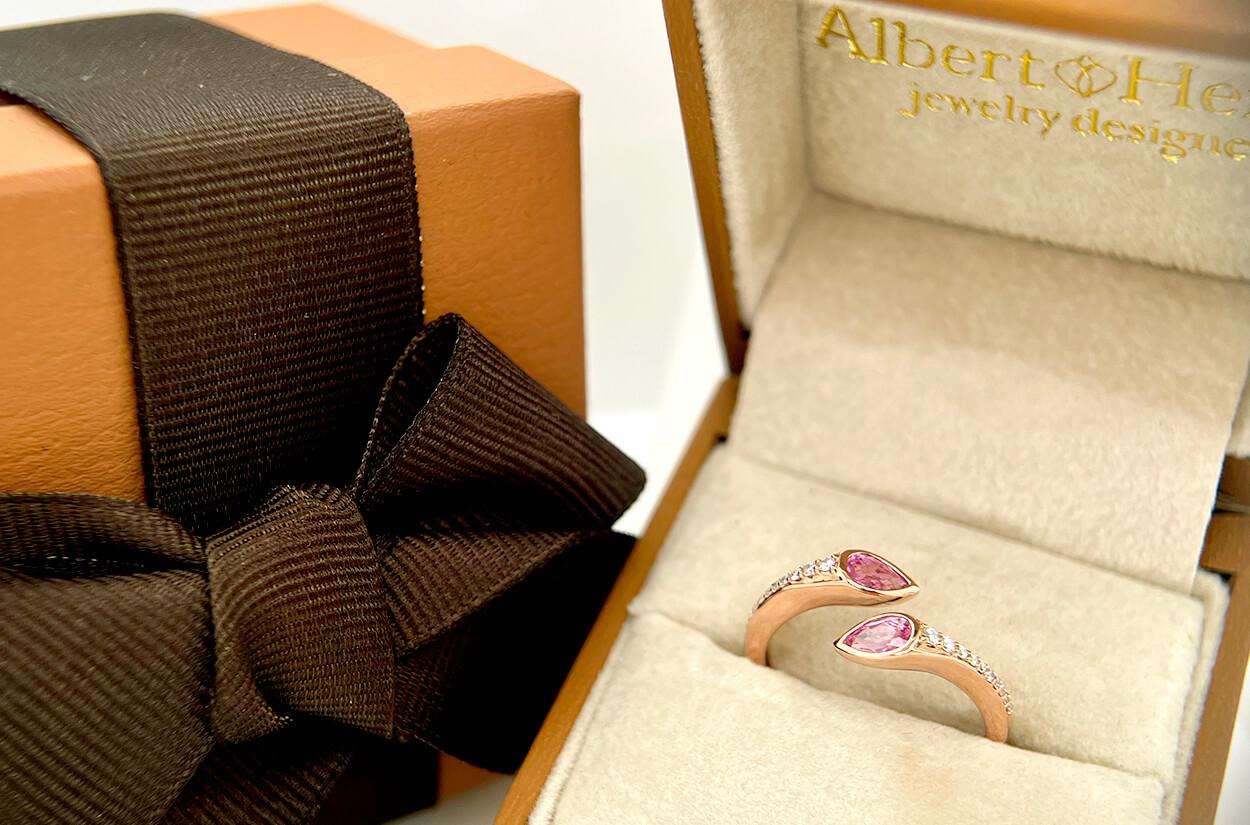 The Bypass Ring in 18kt Rose Gold is a captivating expression of romance and grace. Two pear-shaped pink sapphires, like tender petals, grace either end of the ring, their delicate color evoking feelings of love and tenderness. Embracing these