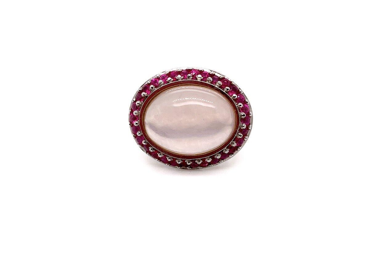 A celebration of elegance and timeless femininity, this captivating ring is crafted in luminous 18kt white gold. At its heart lies a beautifully polished oval pink quartz cabochon—softly luminous and delicately alluring. Encircling the centerpiece