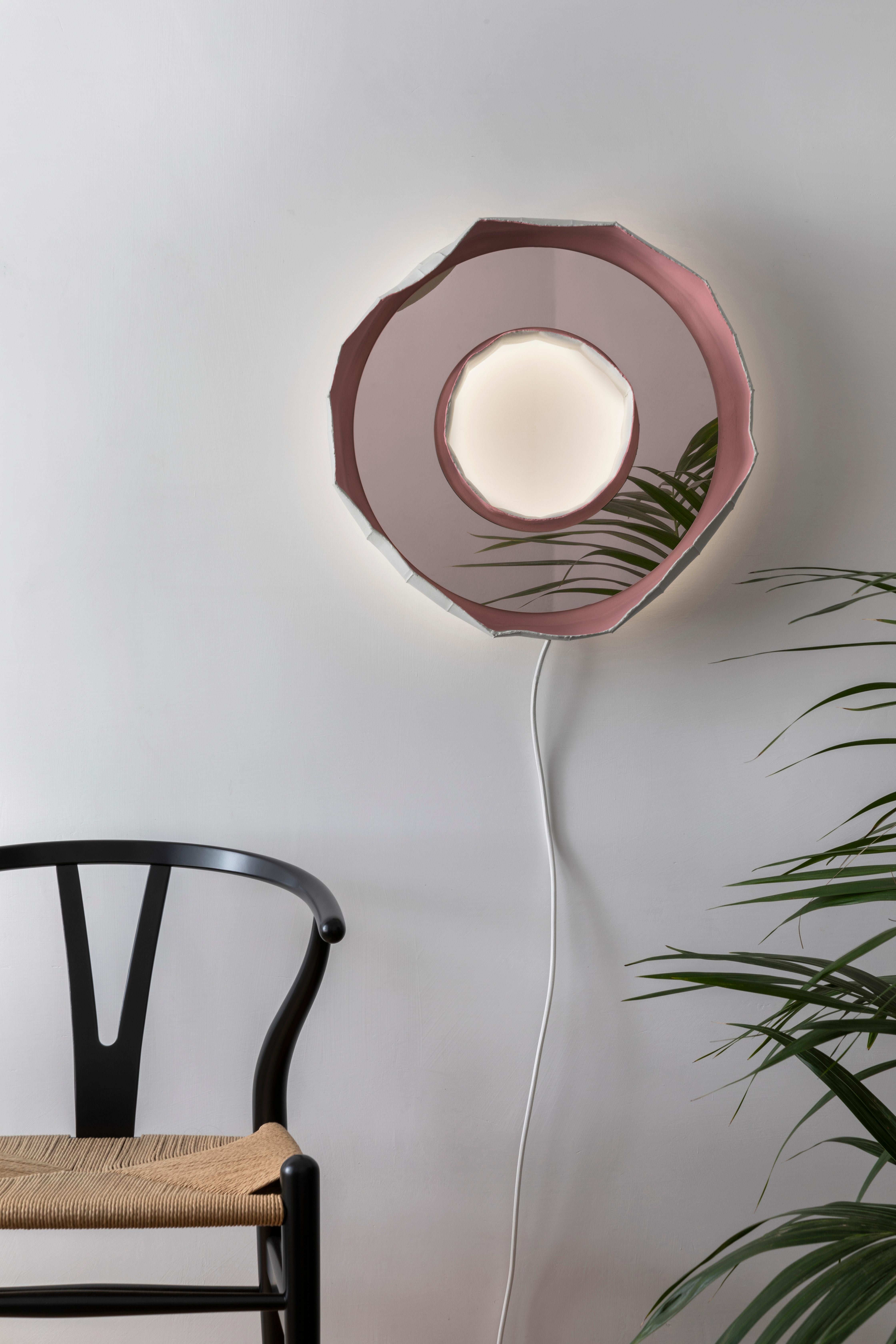 Ring Aura, a stunning mirror-lamp handmade in Italy, one of 2 designs that make up the collection Reflections, the result of a collaboration between artist Paola Paronetto & designer Giovanni Botticelli, that integrates ceramic with colour, glass