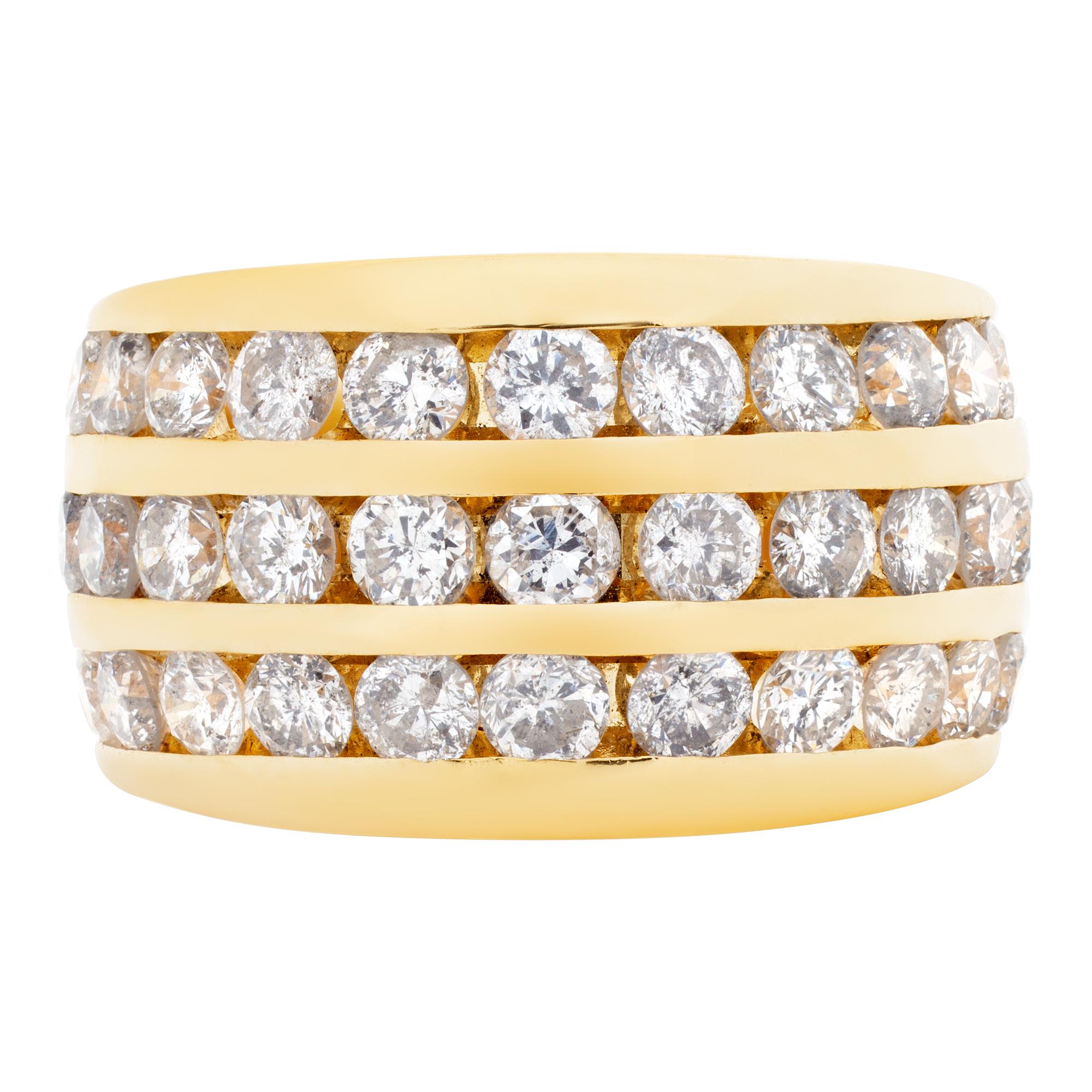 Wide ring band in 14k with approximately 1.50 carats in 3 rows of channel set diamonds. 0.44
