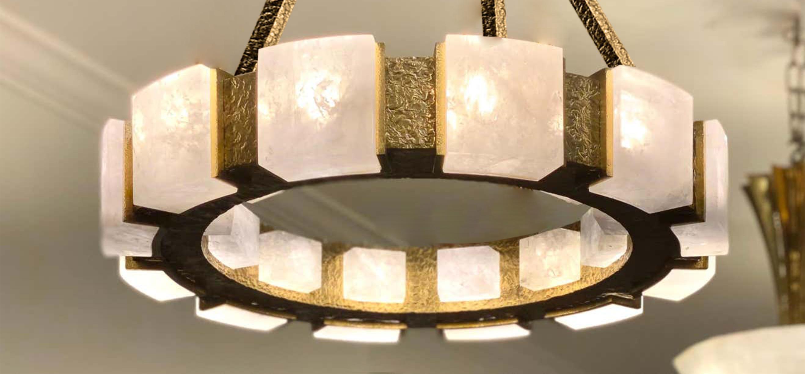 A pair of rock crystal chandeliers with hammered brass detail. Created by Phoenix Gallery, NYC.
12 sockets installed. Use 12 of G9 lightbulbs. 60watts each, total 720w max.
 