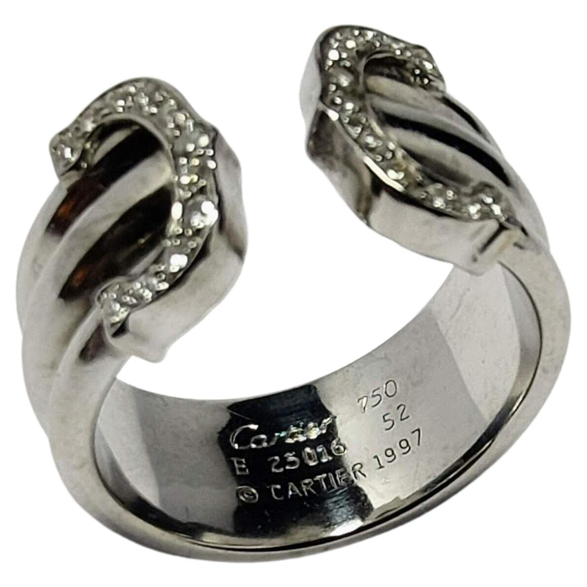 Iconic 1997s Cartier ring model Double C, made of white gold 18 Karats weight 8.10 grams, three-band body the central one wider of 3.5 millimeters in width and the lateral ones of 2.75 millimeters respectively. Letters with 22 Diamonds in brilliant