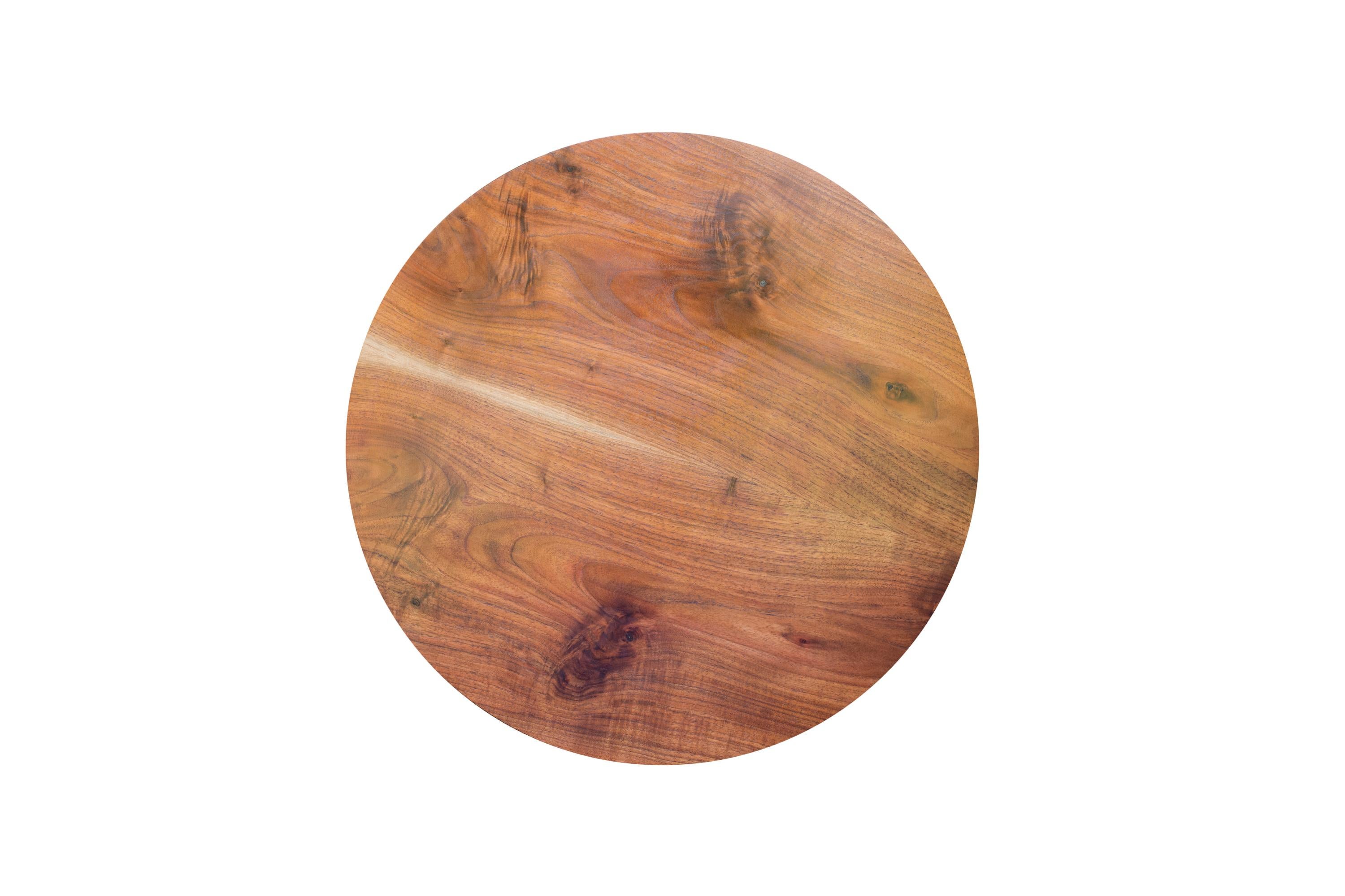 The circular top on this one of a kind coffee table is a single bookmatched board of South Carolina Walnut with a subtle beveled edge and a line of pale new growth sapwood down its center. The four hand-turned and tapered legs are bound with a band