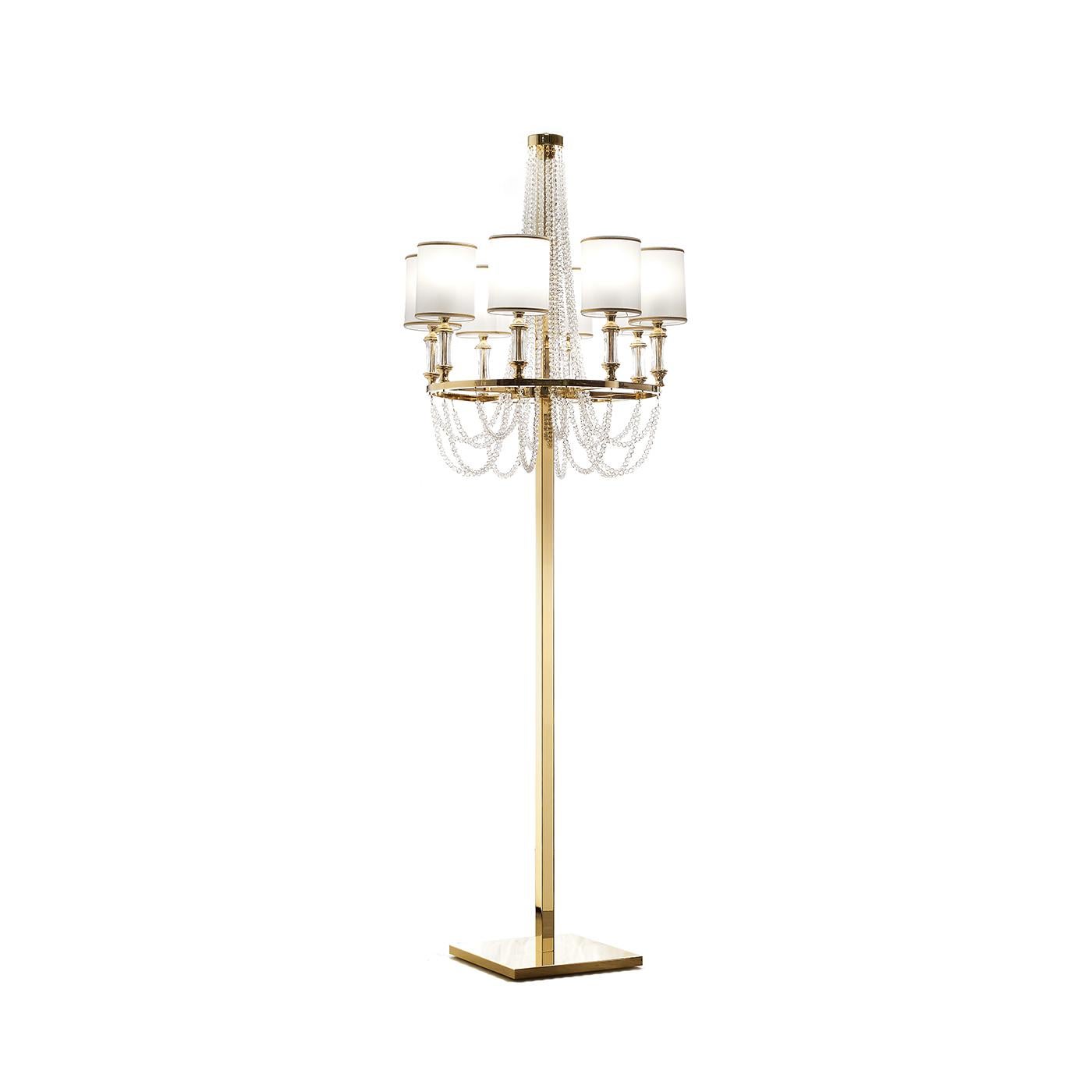 This charming floor lamp combines Art Deco design and a romantic allure for a charming final effect that will make a statement in a classically decorated home. The structure is skillfully handmade in metal with a polished brass finish. The ring at