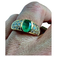 Ring in 18 Carat Yellow Gold Set with an Emerald Surrounded by Brilliants