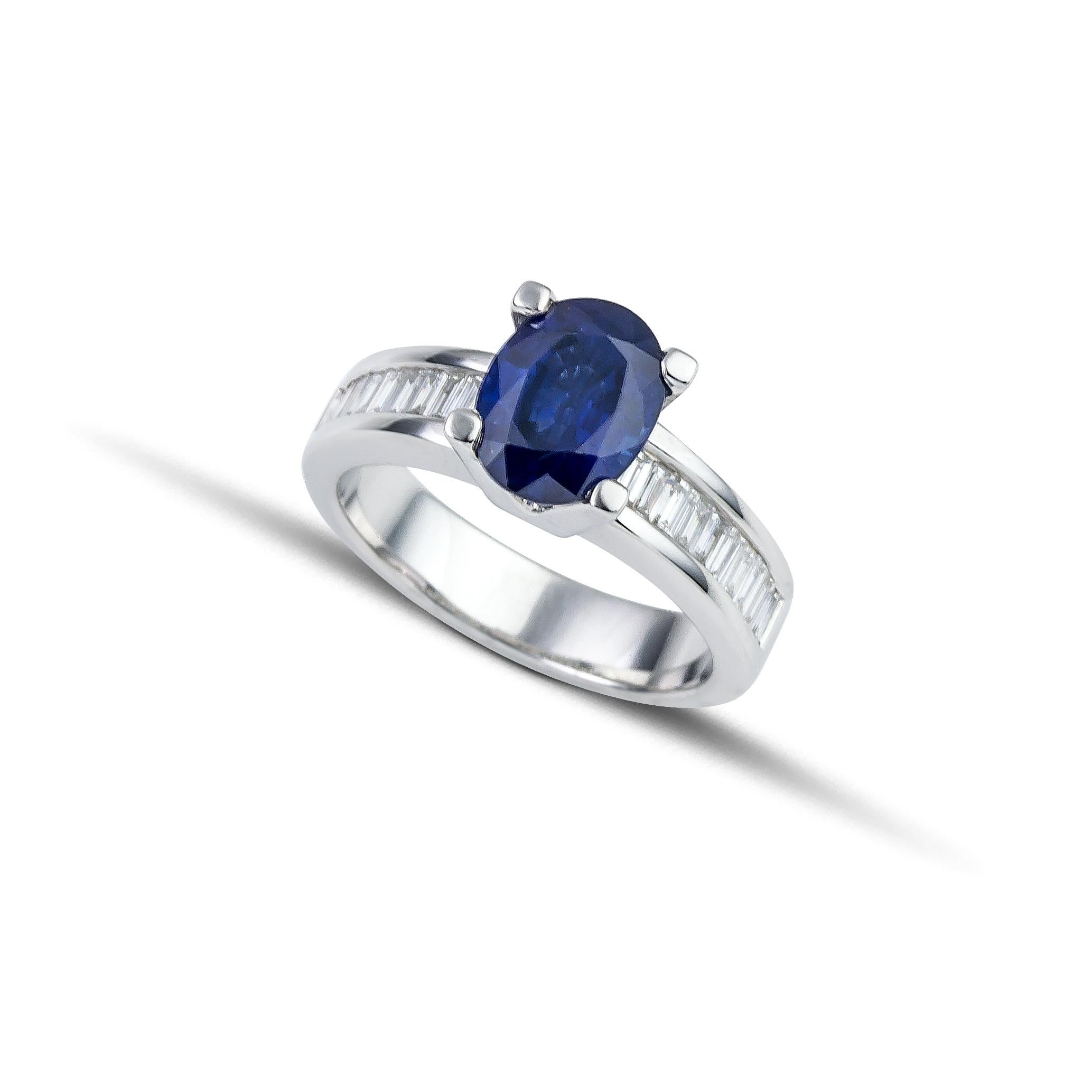 Unique solitaire ring made of 18Kt white gold and oval blue sapphire 2.90 ct and baguettes cut diamonds 0.53 ct on the shoulders. The big oval blue sapphire is set among four prongs, while the diamonds are carefully put on the shoulders of the ring.