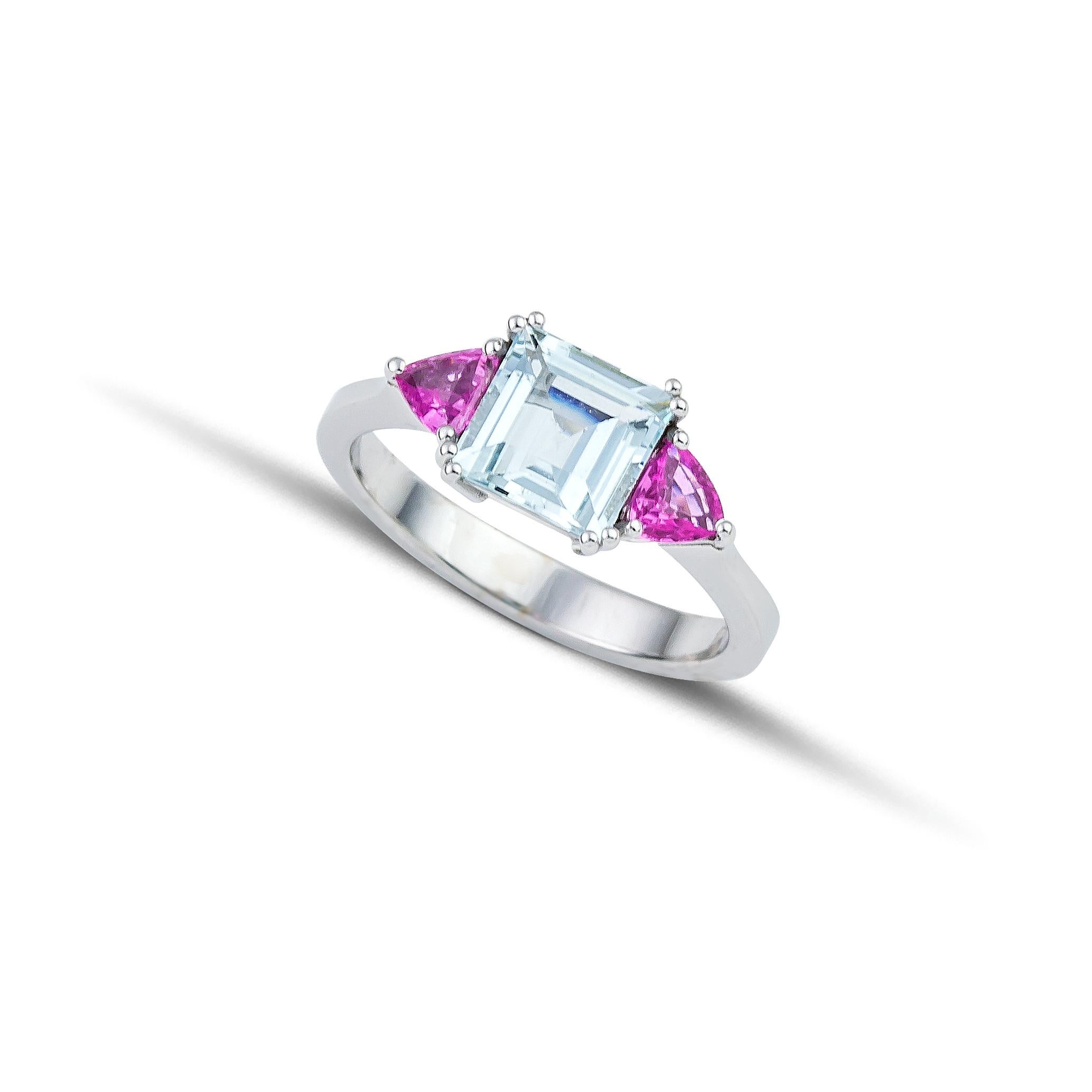 Unique coctail ring made of 18Kt white gold with an Square Cut Aquamarine and two trillion Pink Sapphires. The Aquamarine is carefully set among  double claw prongs and theTrillion Pink Sapphires are set among three gold prongs. This simple but