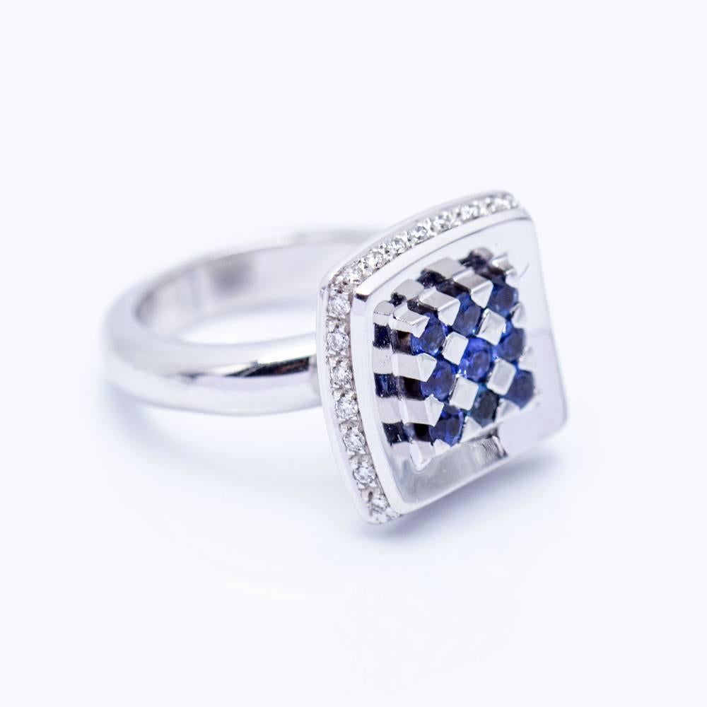 Gold ring in square shape  Diamonds in Brilliant cut with total weight 0,56cts. in quality G/VS  Sapphires with total weight 0,45cts.  Size 12, the size can be adapted (Consult budget)  18 kt. white gold  13,90 grams.  Brand new product I Ref: