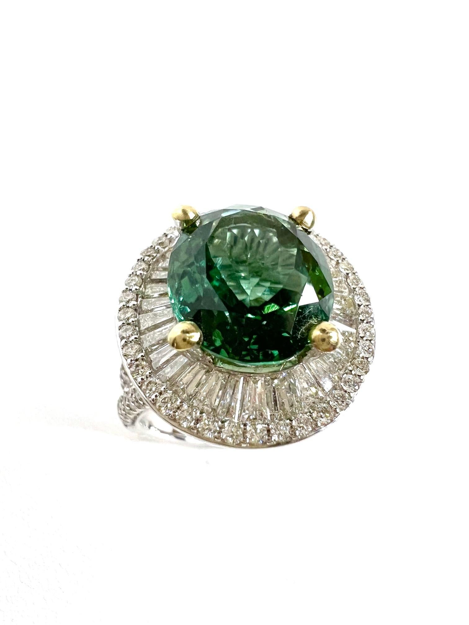 Thomas Leyser is renowned for his contemporary jewellery designs utilizing fine gemstones.

Ring in 18k White Gold (12gr.) with a 1x top quality Green/Blue Tourmaline (fac., oval, 13,2x10,8mm, 7,15cts.) + Diamonds (tapez-cut, I/VS-SI, 2,56cts.) +