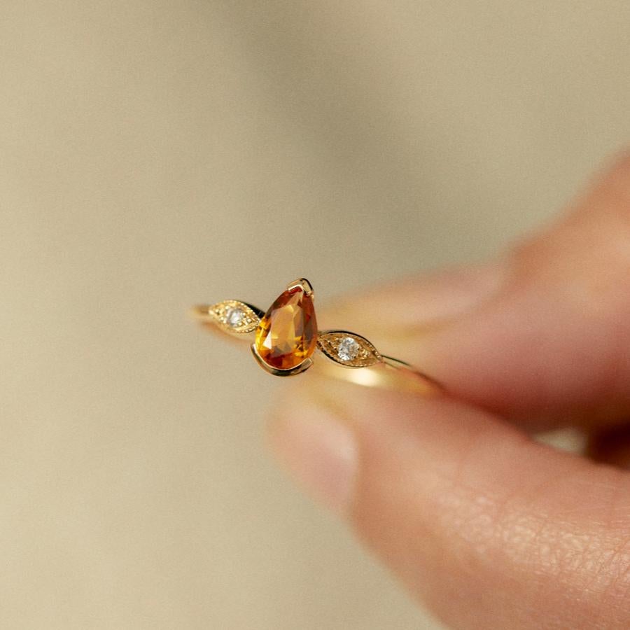 Mademoiselle by Monsieur Paris, the precious ring that your heart desires. Made of a central drop-shaped citrine and two encrusted diamonds that elevate the stone, the Mademoiselle ring is in 18 karat yellow gold. The ring Mademoiselle in handmade