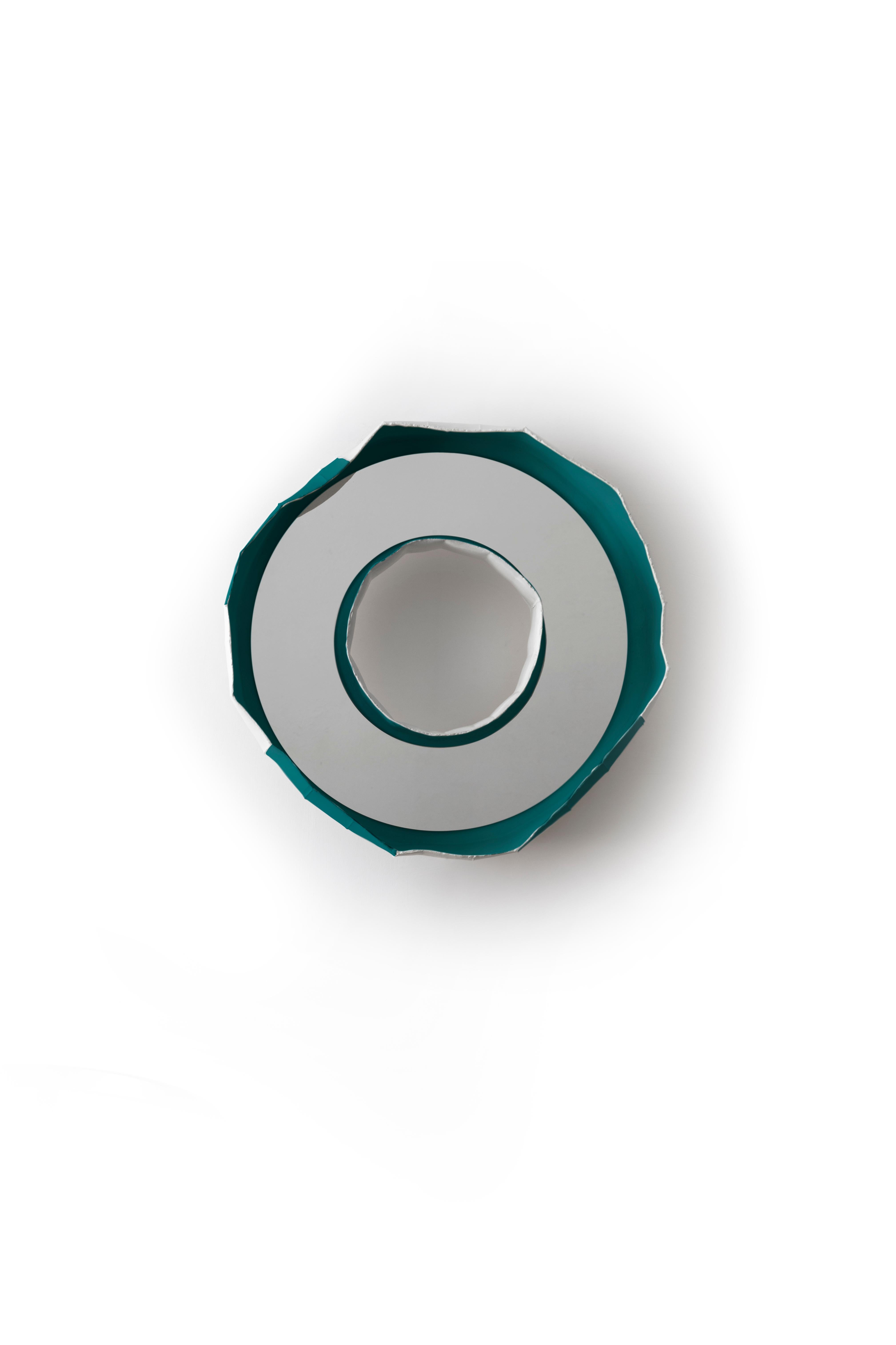 Handmade in Italy by Paola Paronetto & Giovanni Botticelli, this mirror merges ceramic with glass. REFLECTIONS, a fusion of distinctive materials developed by their creators, unites an apparently light material such as paper clay with the crisp
