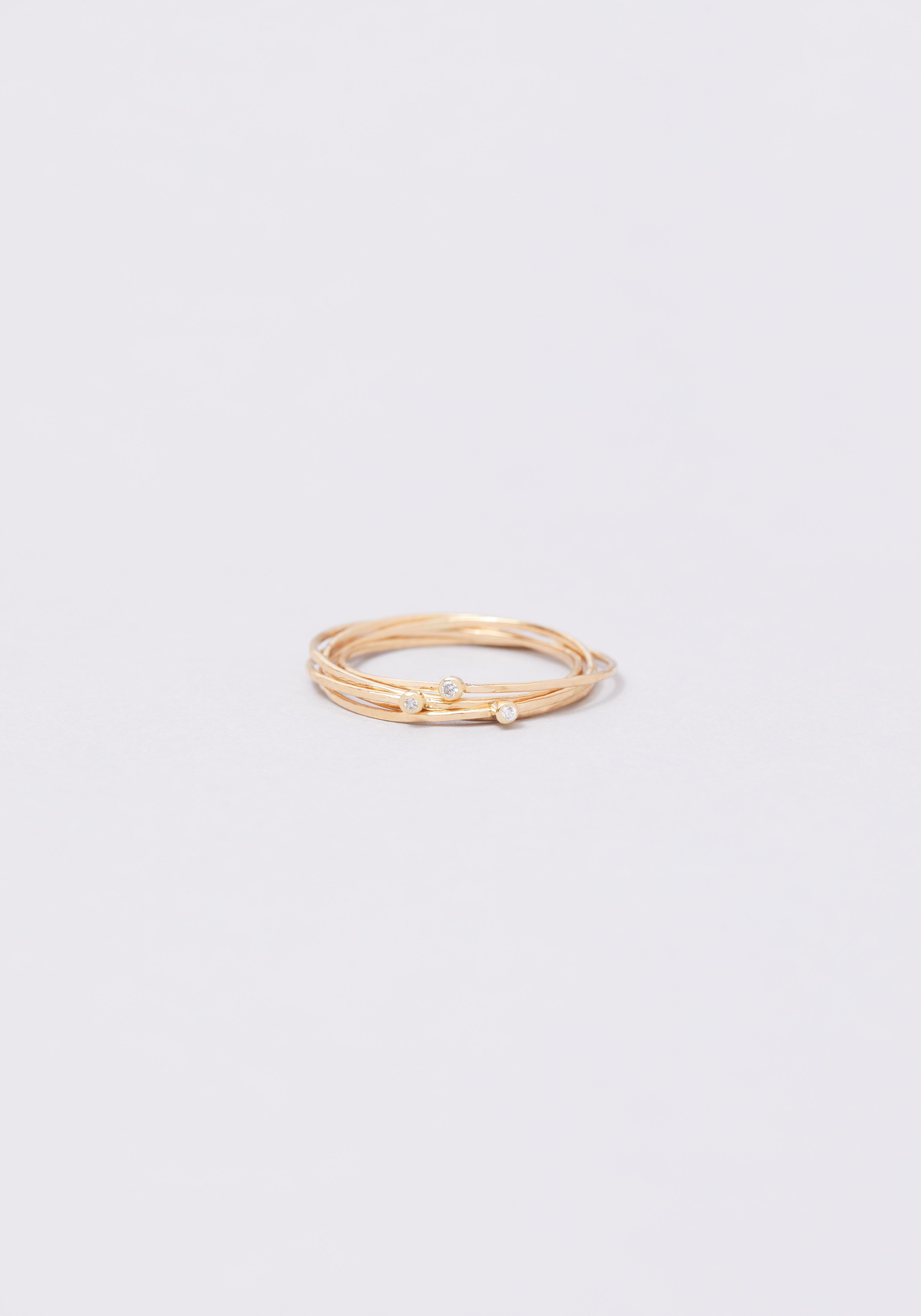 A variation of the Olympe ring, the first Monsieur Paris deisgn, the Olympe 3 tubes in 18-karat gold is made up of five interlaced bands with white diamonds. Available in yellow, rose, or white gold, the Olympe 3 tubes ring can be worn on its own or