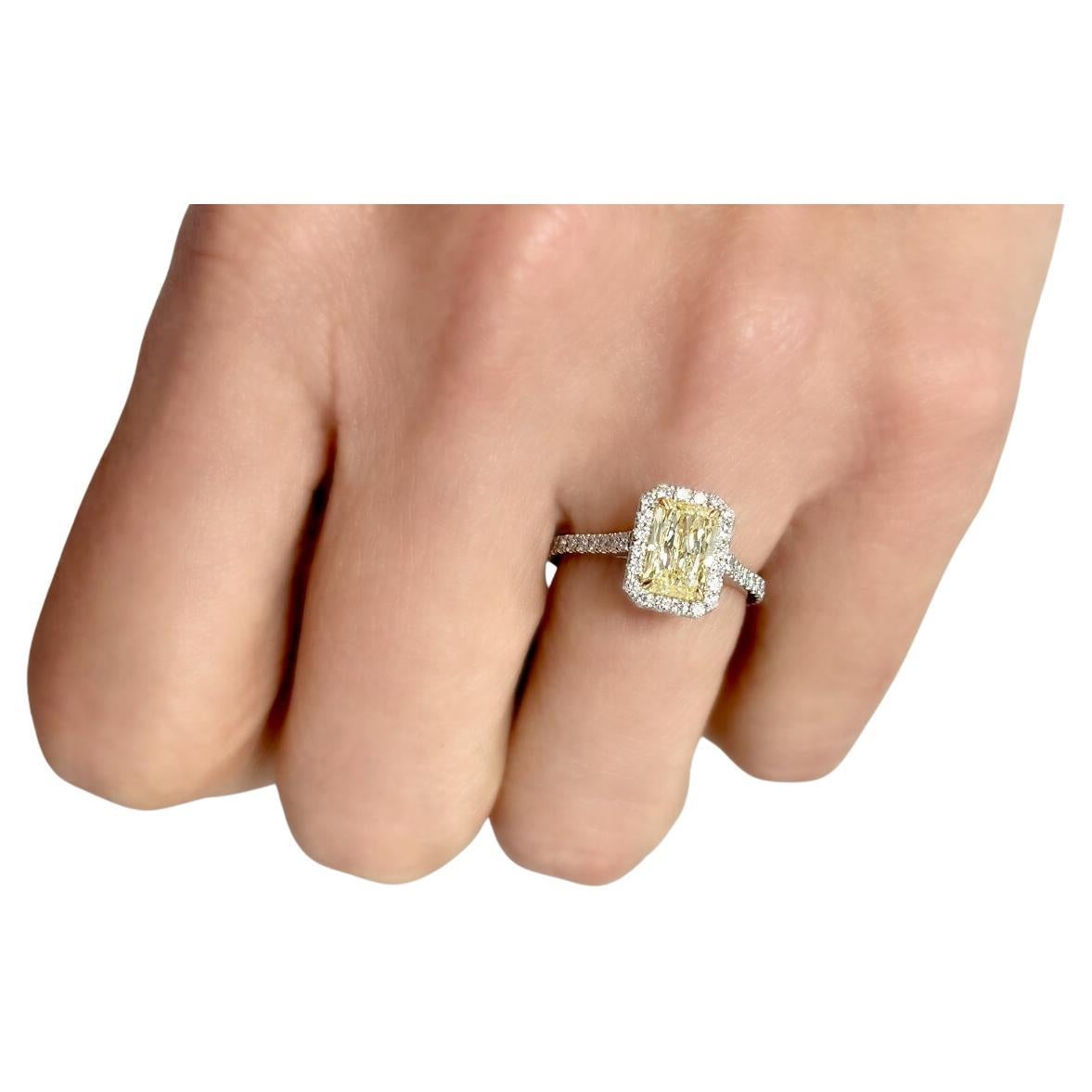 Crafted from Platinum the magnificent engagement ring comes enriched with 1.36 carats Cut-Cornered Rectangular Fancy Yellow Diamond Clarity SI1 GIA #6187262843 with Yellow Gold Settings and 50 Pave Diamonds 0.41 carats Split Shank. Size 6.

Perfect