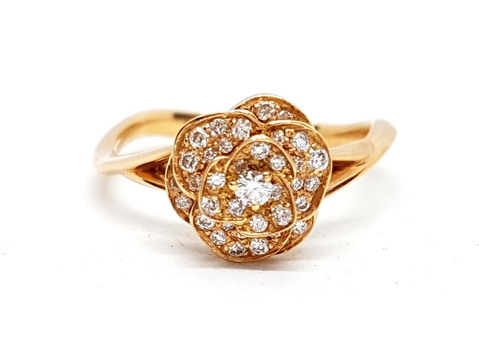Ring gold flower rose 750 mils (18 carats). petals pavers round brilliant cut diamonds 0.35 ct total ring with wave motion. ring size: 53. flower diameter: 0.97 cm. total weight : 2.82 g. punch eagle's head. new state
