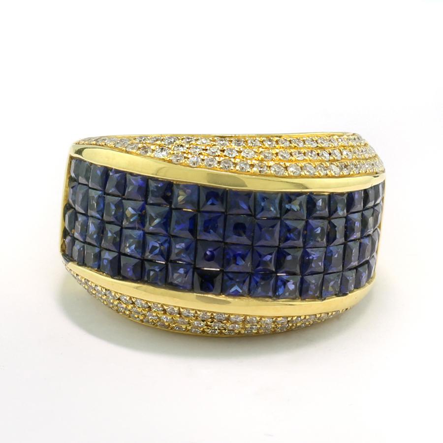 An opulent ring featuring 68 square-cut sapphires  approx. 3.30 carats in total, displaying a transparent deep blue hue, set in an open channel setting. The sapphires are aligned edge-to-edge, forming a wide blue band that runs slightly diagonally