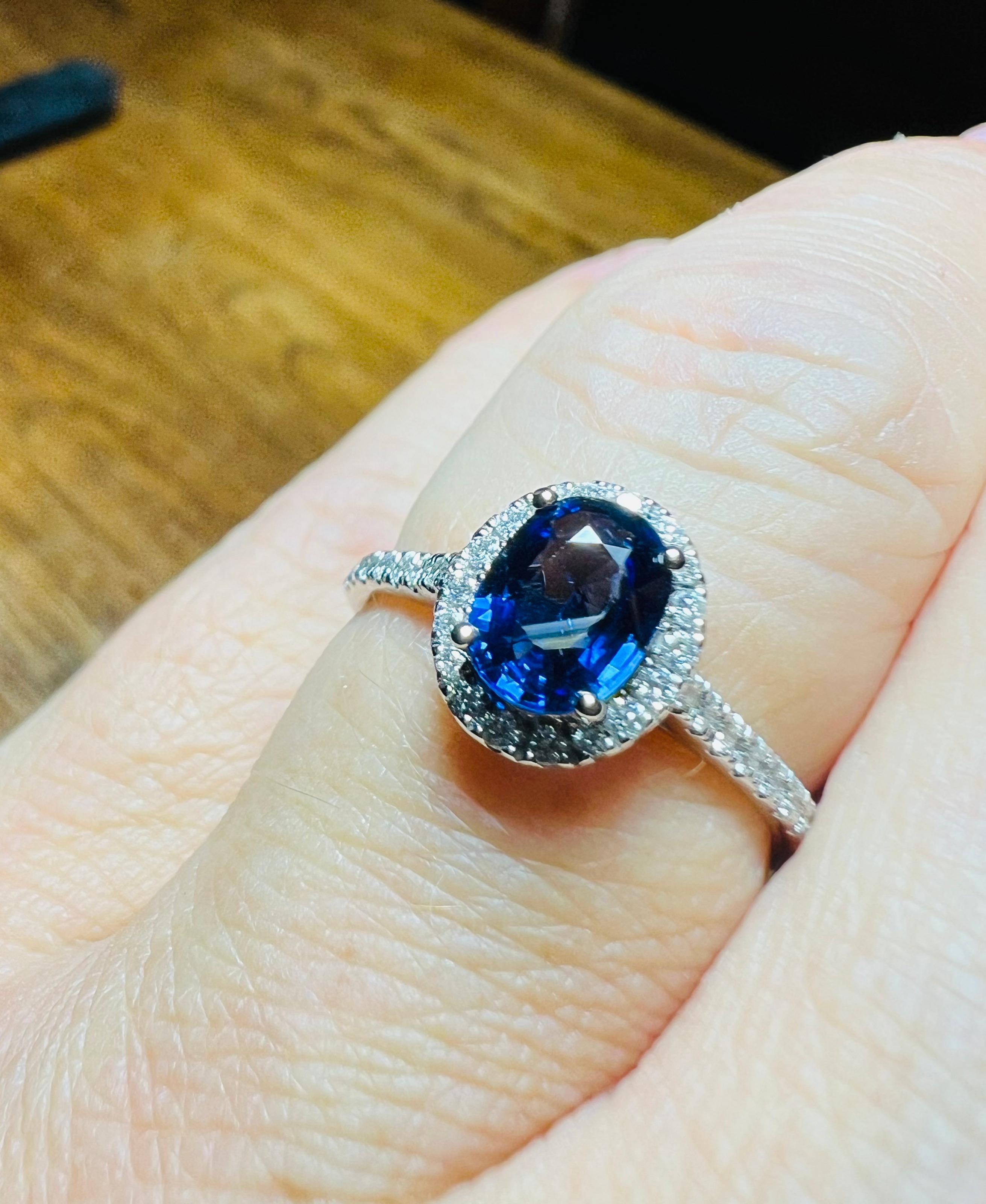superb translucent deep blue sapphire 
surrounded by a paving of diamonds, 
ring in 18 carat white gold 
weight of the sapphire, oval, faceted: 0.89 carat
 weight of the paving of diamonds: approximately 0.23 carat in total total weight of the ring: