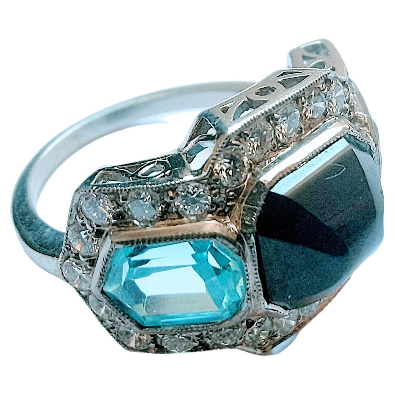 Beautiful symmetrical ring made of platinum weight 6.78 grams, with beautiful openwork drawings on the sides. Central sapphire cut cabochon sugar loaf, measure 9.68x 8.25x 4.82 millimeters, weight 3.85 cts. With two seawater of beautiful light blue 